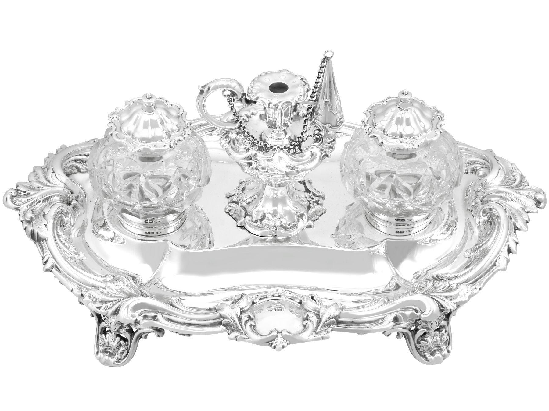 An exceptional, fine and impressive antique Edwardian English sterling silver and glass desk standish; an addition to our ornamental silverware collection

This magnificent antique silver desk standish, in sterling standard, has an oval shaped
