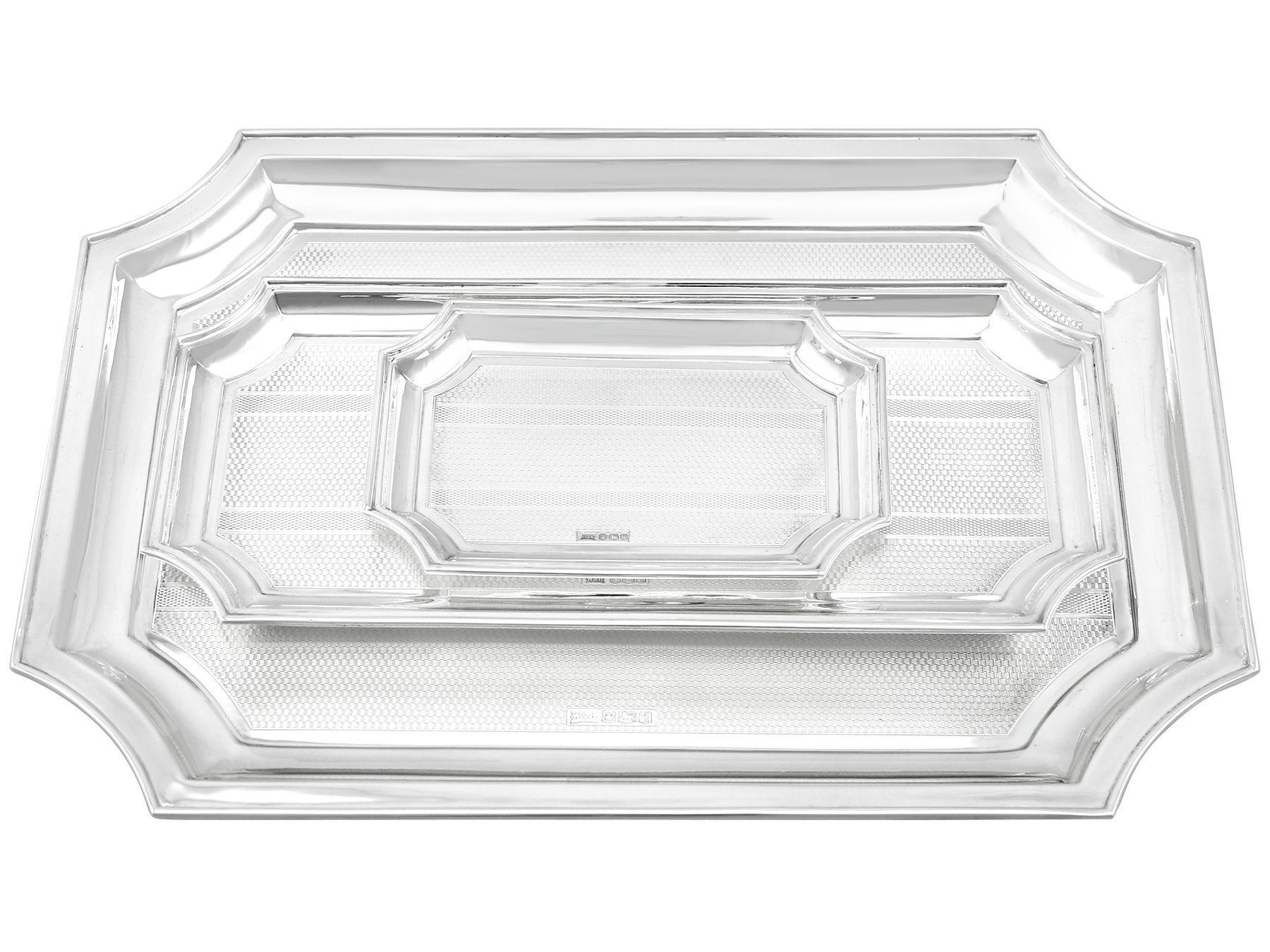 An exceptional, fine and impressive set of three antique George V English sterling silver trays - boxed; an addition to our range of collectable dining silverware.

These exceptional antique George V sterling silver trays have been crafted in