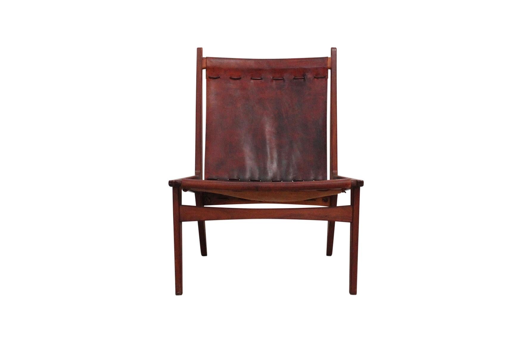 Leather sling and walnut lounge chair designed by New Hampshire craftsman Walker Weed. In 1964, he was selected as Director of the Crafts Program in the Hopkins Center at Dartmouth College. He mentored many students in the art of working with wood