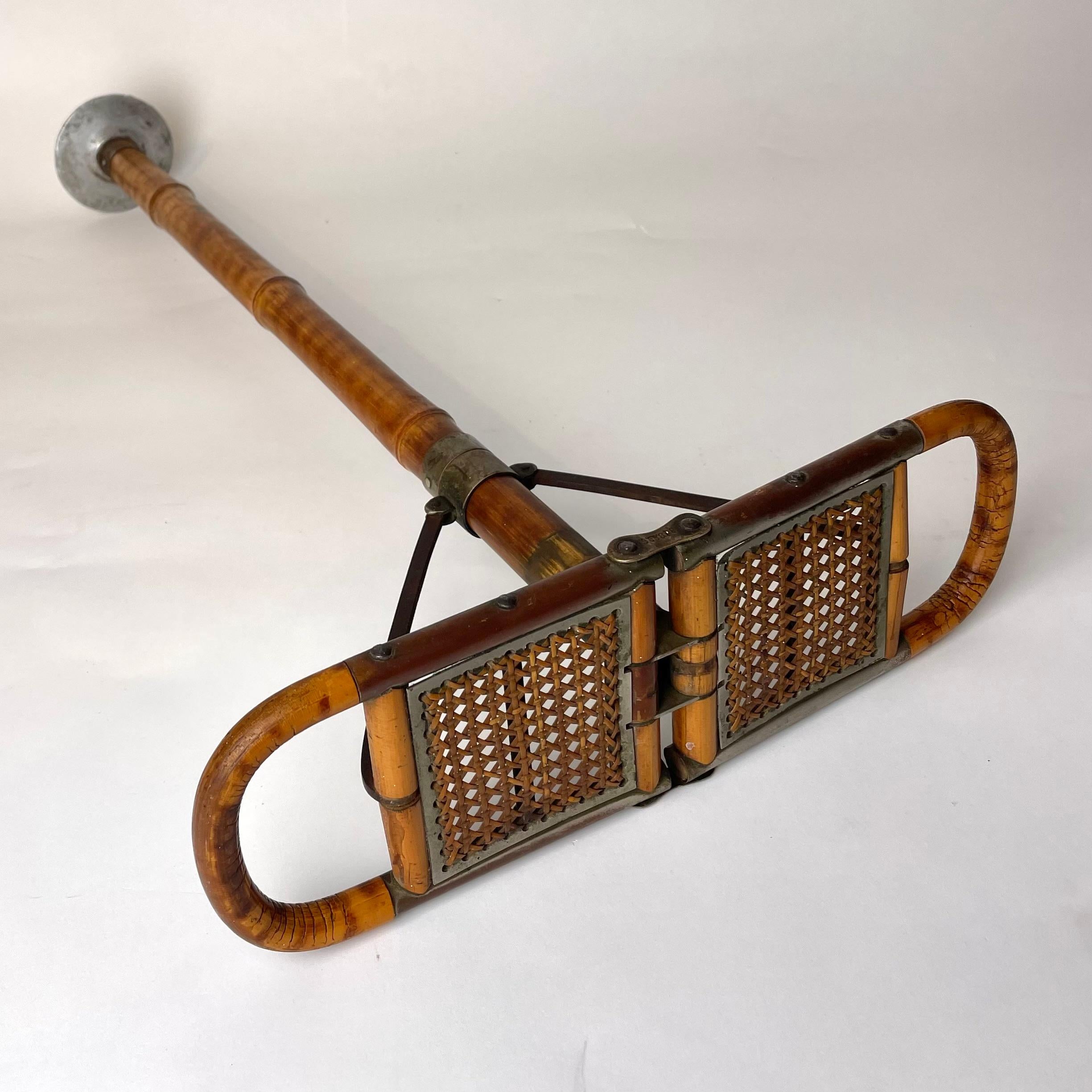 A charming Walking Cane with Folding Seat. Made of Bamboo, Rattan and Iron, late 19th/early 20th Century.

This walking cane has a foldable seat, allowing one to rest while on a walk or hunting. The end, made of iron, is simply thrust into the
