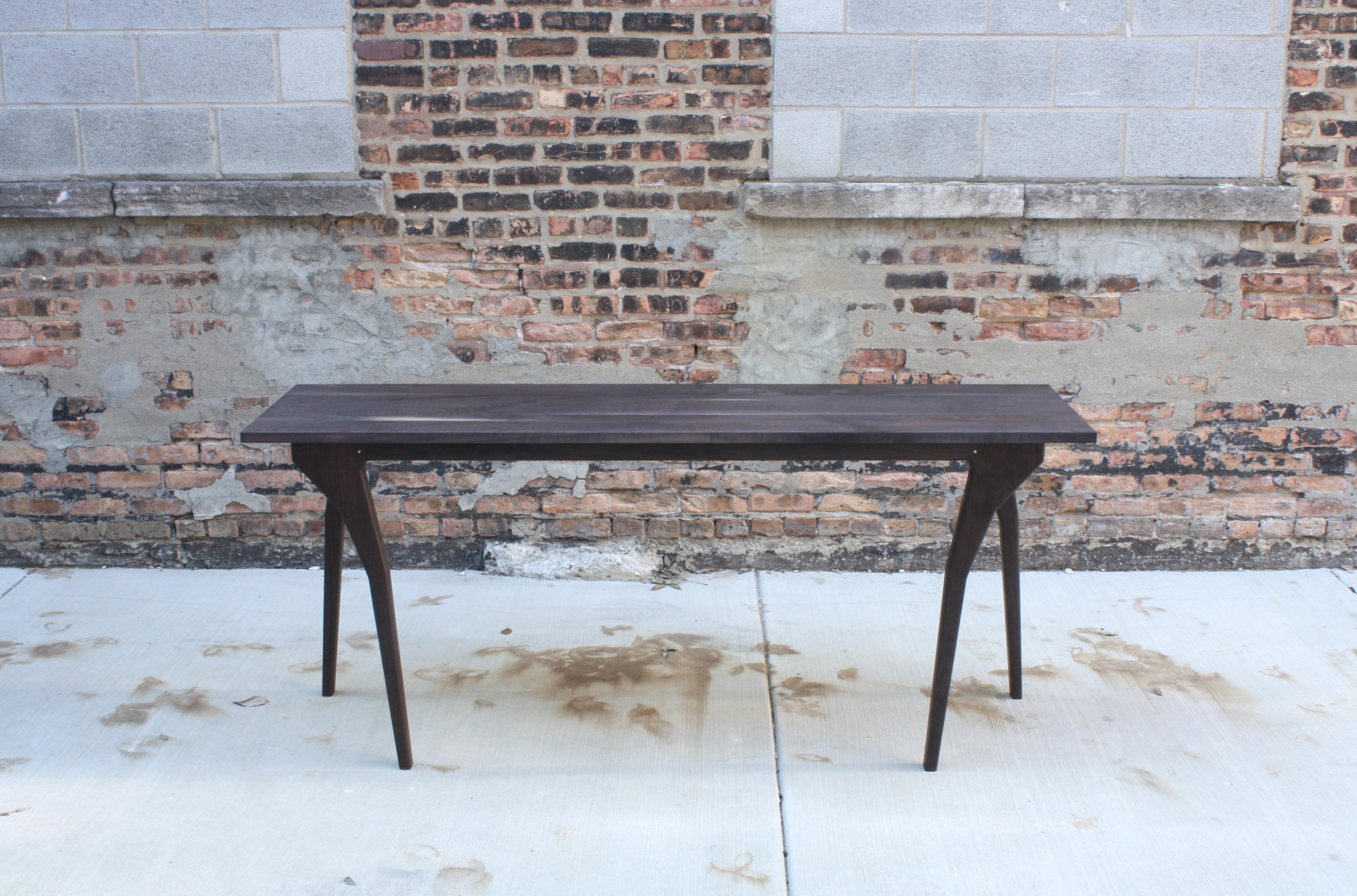 Handmade in Chicago by Laylo Studio, this personified table showcases proportion modeled after anatomy. The design of this piece is intended to mimic movement while maintaining an ultimately static pose. Constructed using brass pins to drawbore