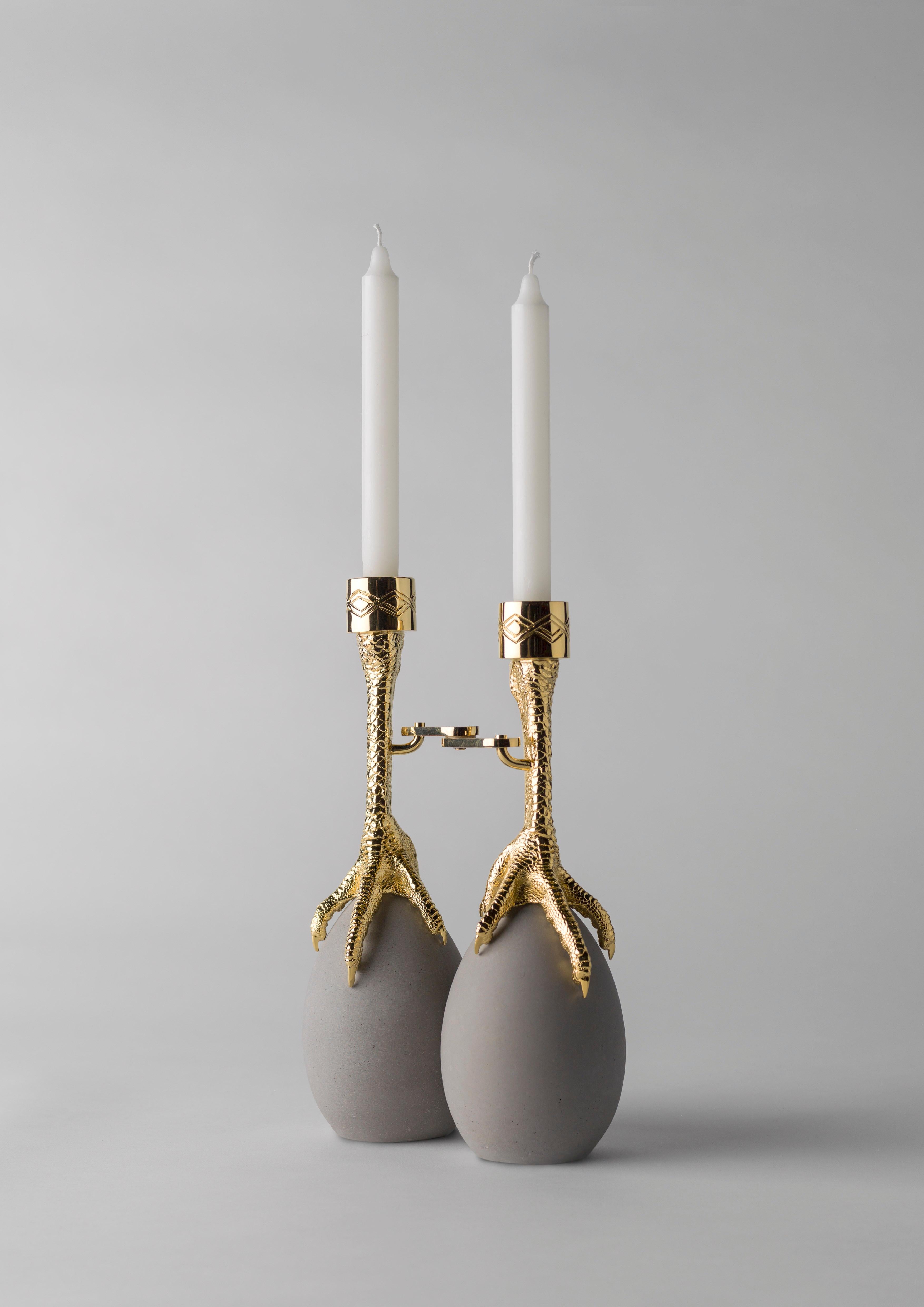 Walking hen gold plated candleholder by Aisha Al Sowaidi
Limited edition 8 pieces + 2 prototypes + 2 A.P.
Dimensions: 21 x 30 x 7 cm
Materials: Claws in cast brass and hinges in steel - both in a 24 carat gold plated finish. Eggs in concrete.

A