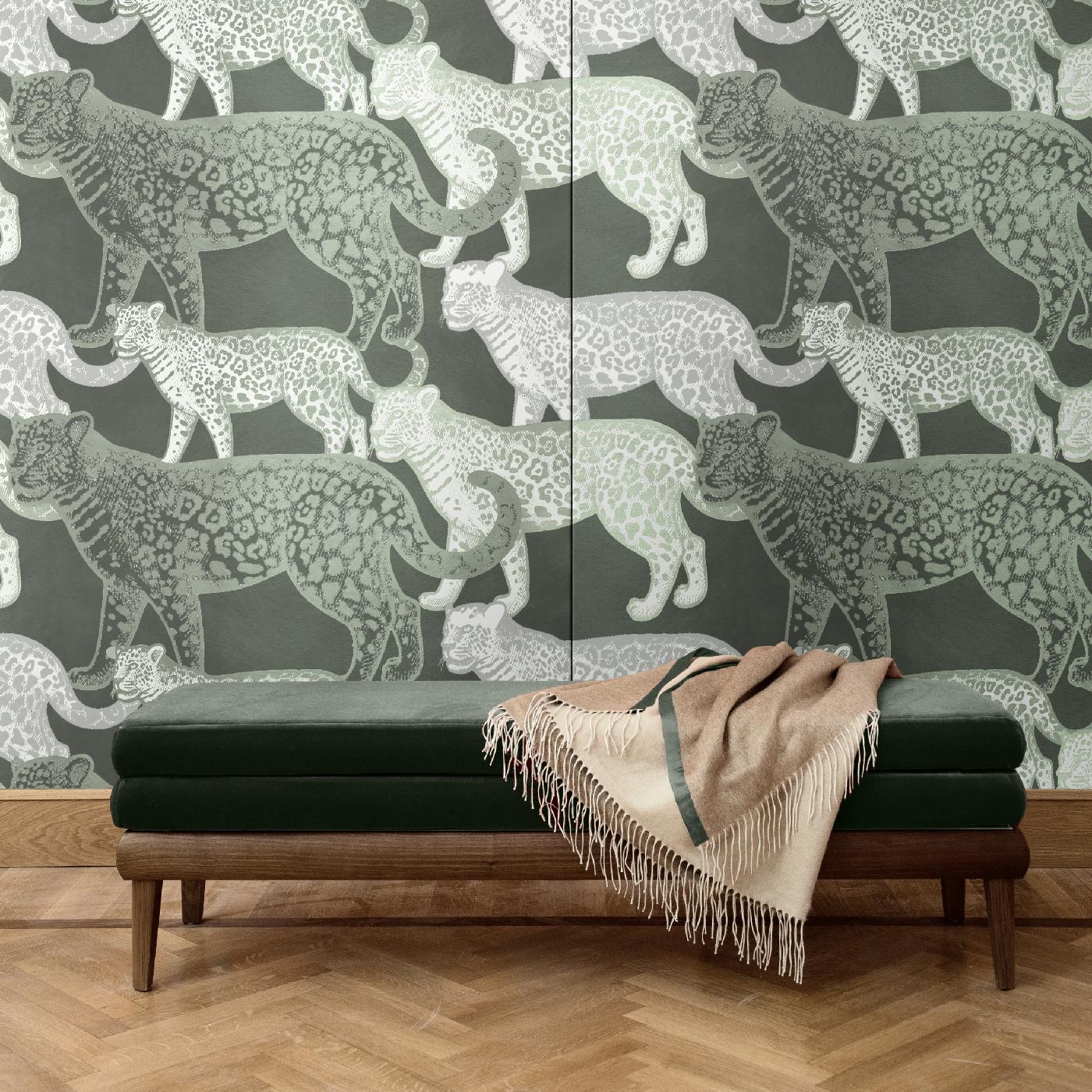 A mesmerizing combination of contrasting colors and naturalistic style creates this bold and sophisticated wall covering, depicting walking leopards of two different sizes. A dream-like scene that will make a statement in any modern interior, this