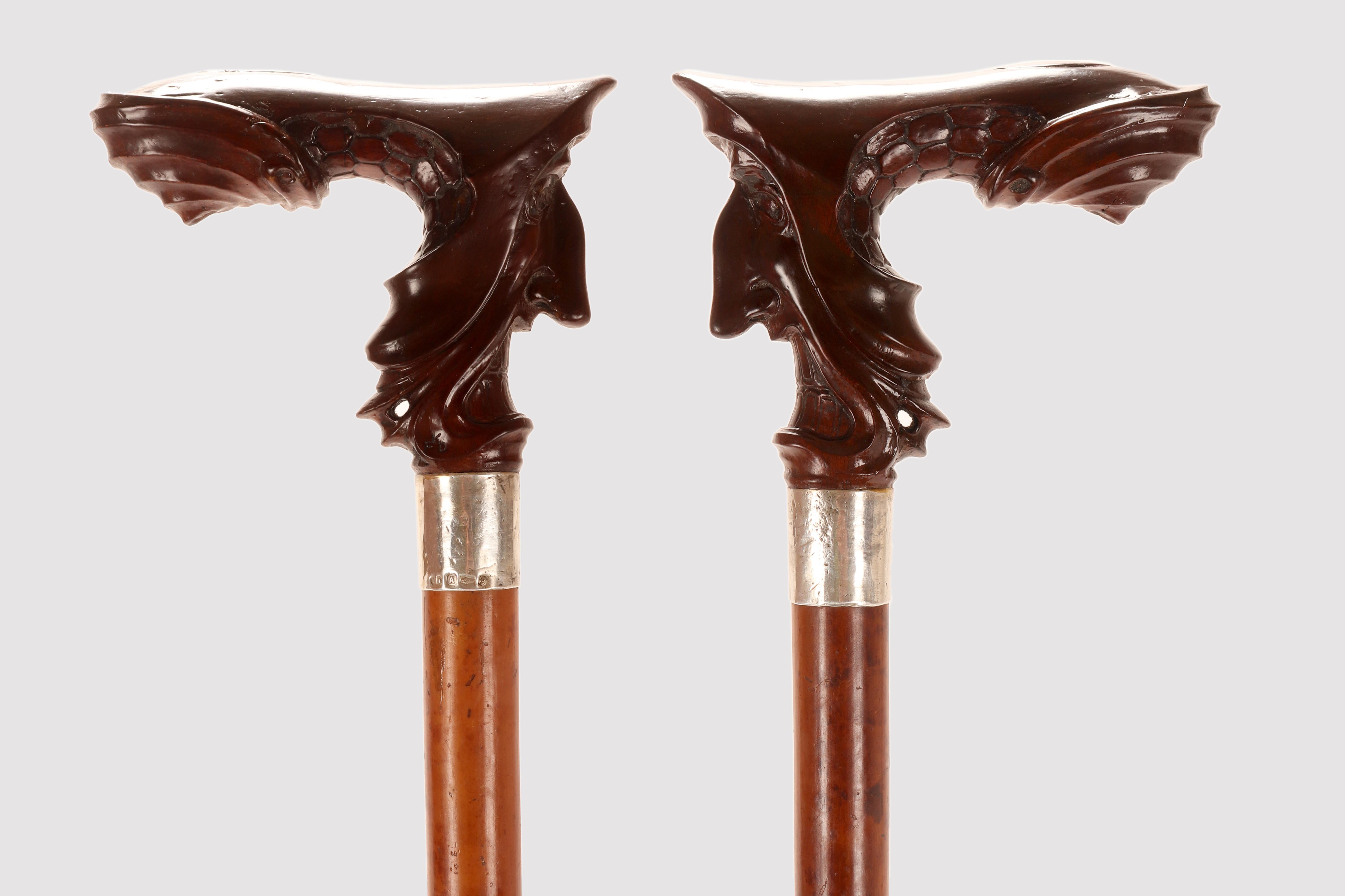 Hazelnut wood walking stick handle, designed and crafted by Franz Karl Delavilla. The finely carved caricature depicts an enraged man, powerfully modeled, with malicious eyes, an aquiline nose, and a wide mouth and bared teeth. His cap wraps around