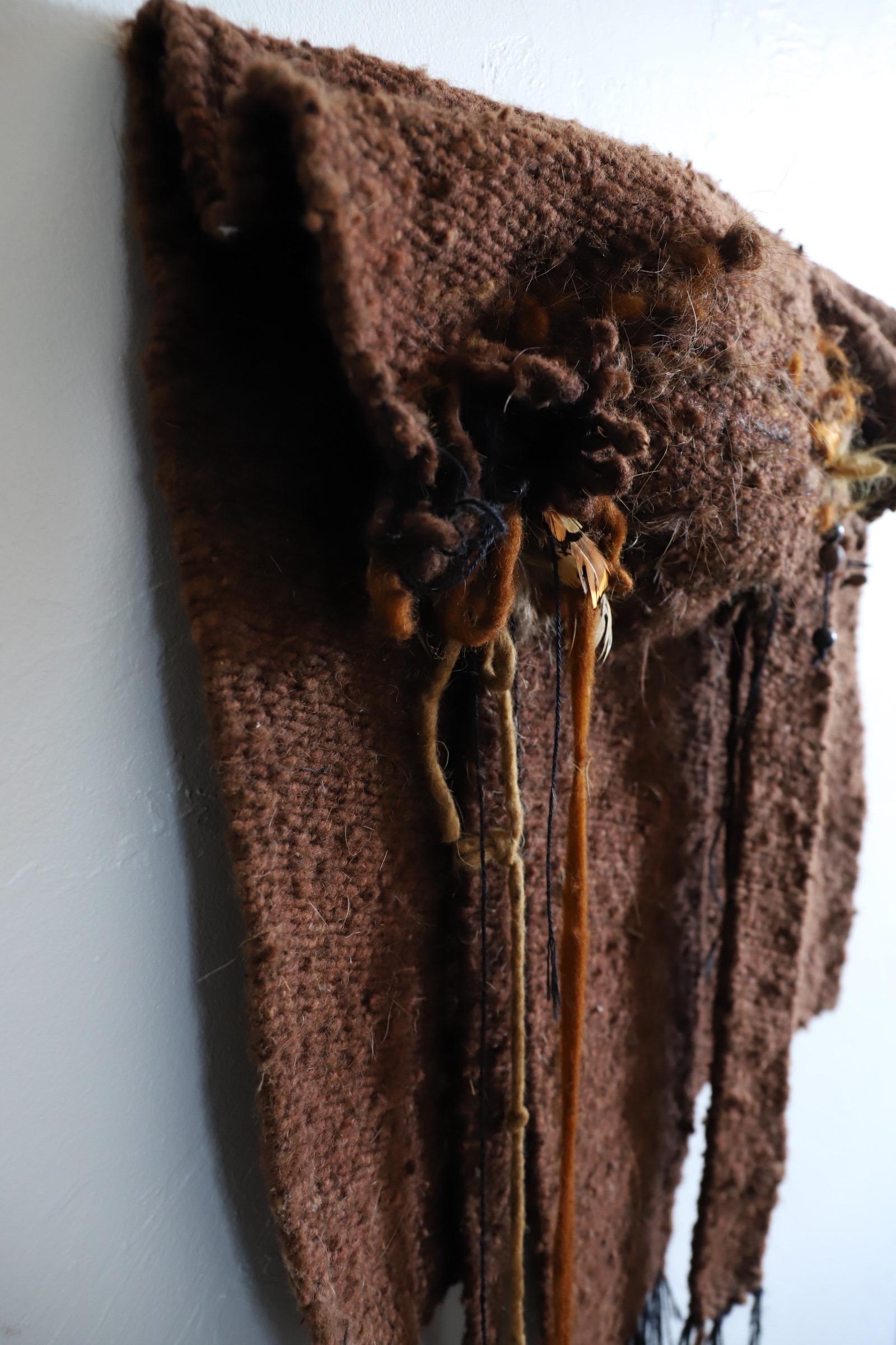 Unique, folded weaving with cascading yarn embellished with tucked feathers & beads. Organic earth tones. Fantastic size, perfect for that smaller wall craving a unique look. Photographed with Arcteryx ball cap for scale.