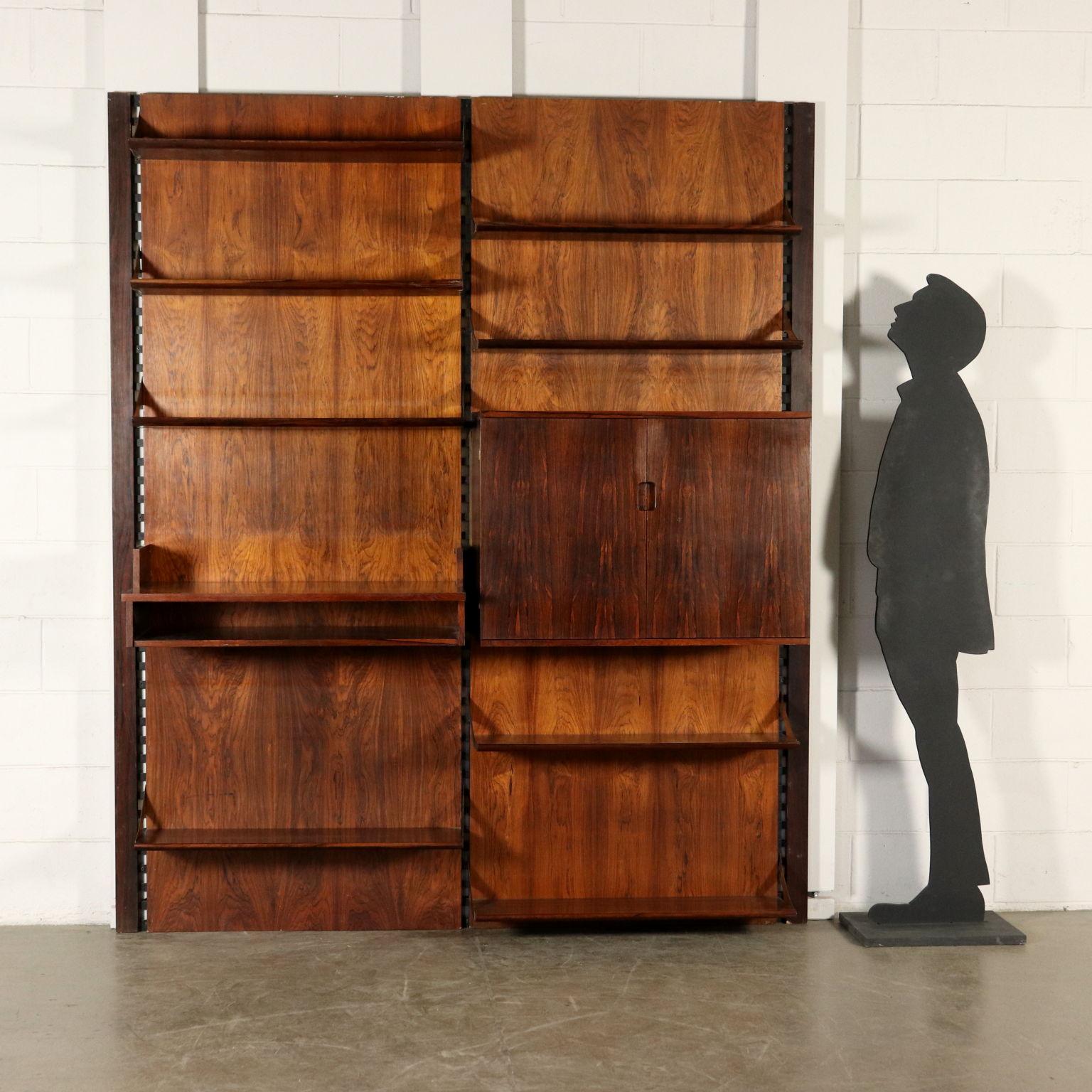 Wall bookcase with adjustable elements. Wood veneer, brass supports. Manufactured in Italy, 1960s.