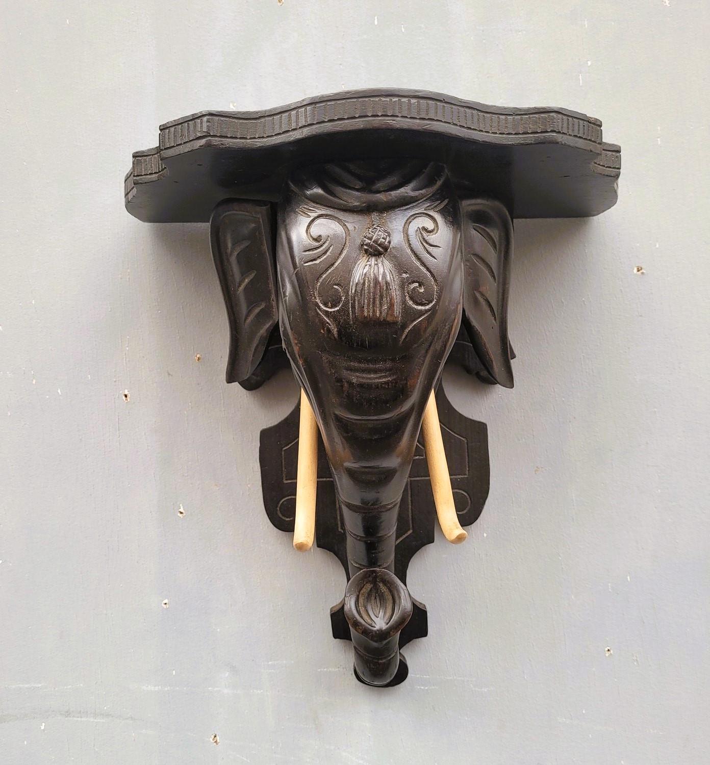 Charming wall console or wall stand entirely in carved wood representing an elephant's head (wooden tusks)

Good general condition, wear of time to the patina, small losses

19th century

Height 34 cm
31 x 19.5cm