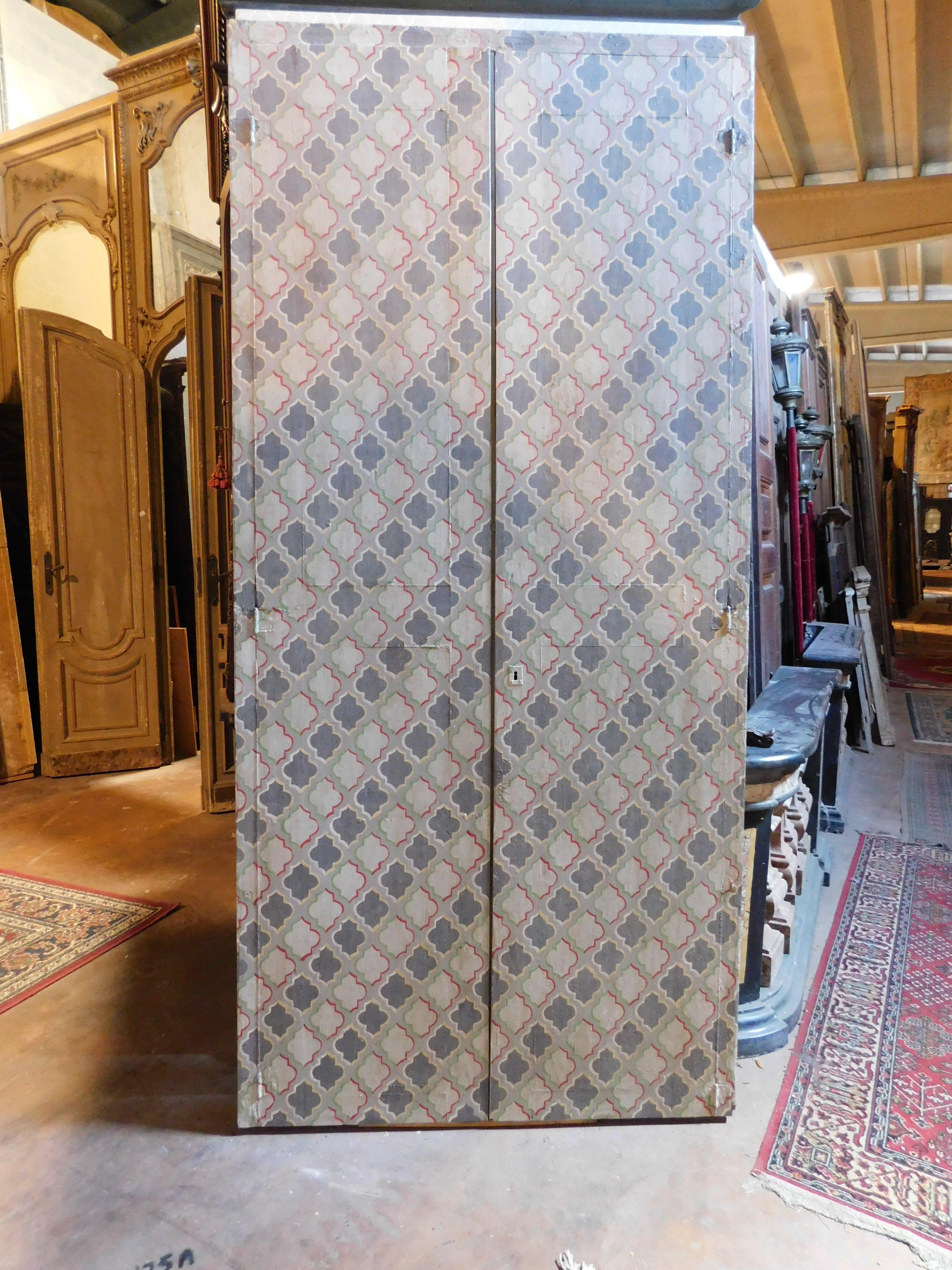 Italian wall cabinet, double wing placard painted with geometric decorations, Italy