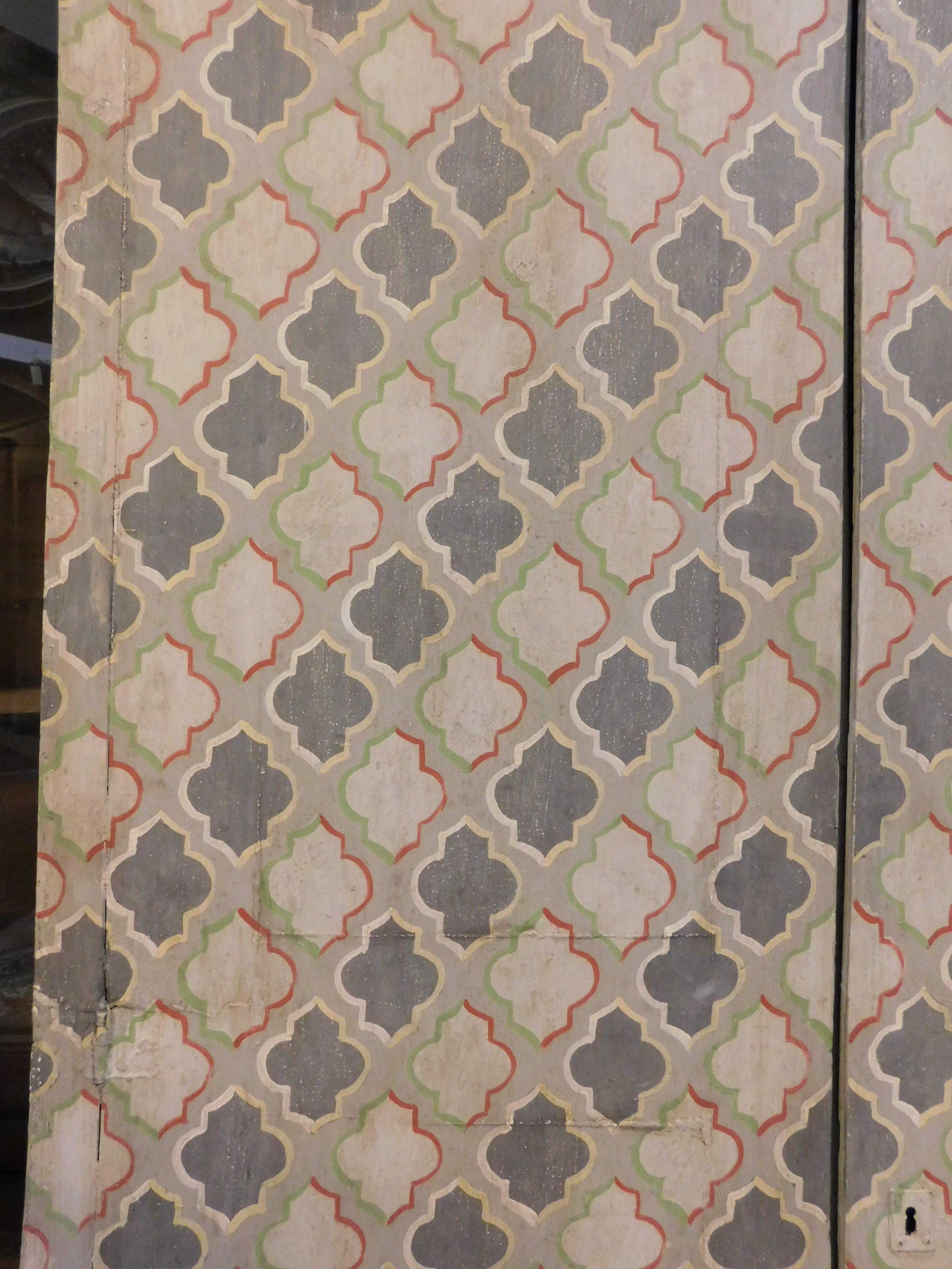 Poplar wall cabinet, double wing placard painted with geometric decorations, Italy