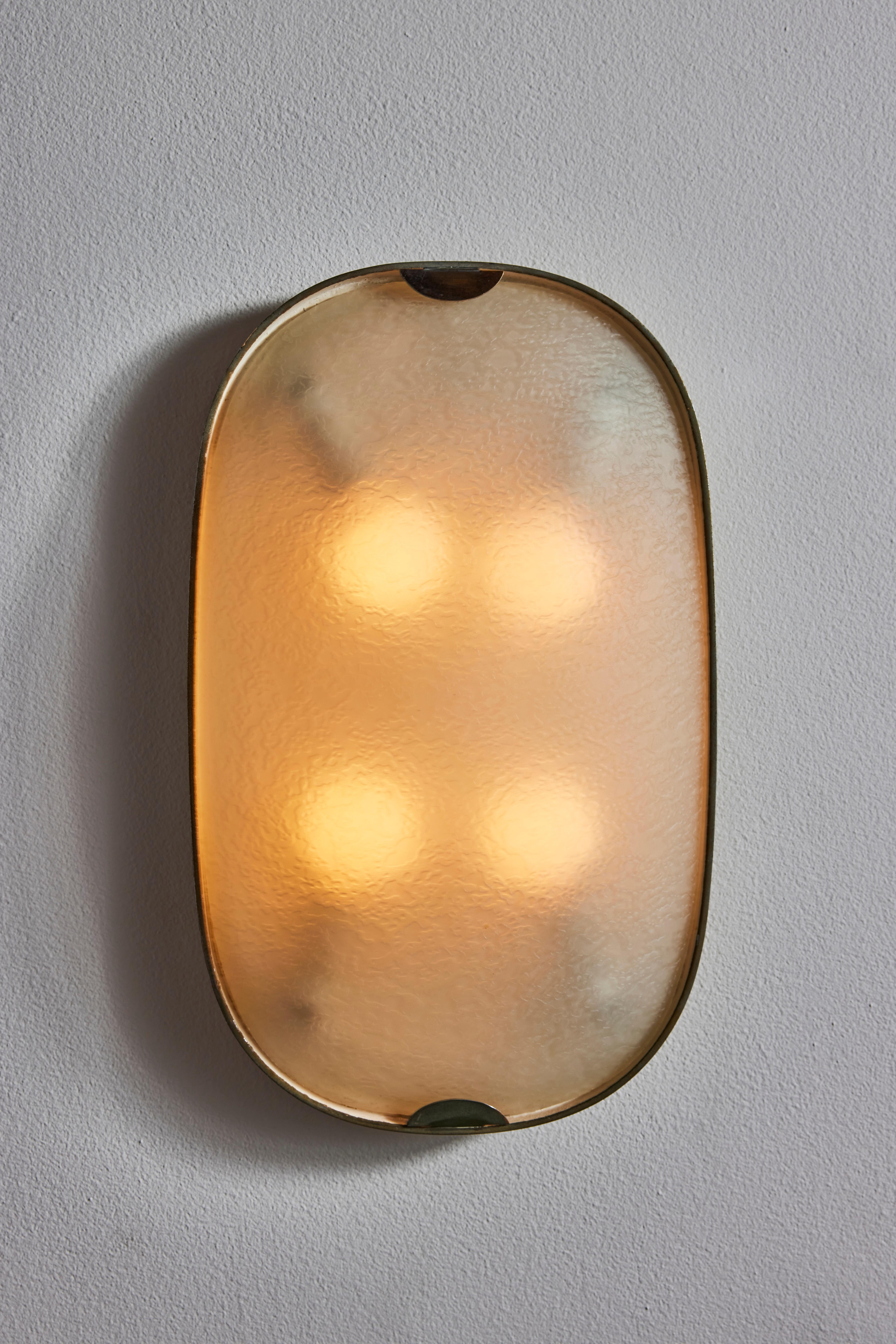 Wall/ Flush mount ceiling lights by Fontana Arte. Designed and manufactured in Italy, circa 1950s. Textured glass, brass. Rewired for U.S. standards. We recommend four E26 25w maximum bulbs. Bulbs provided as a one time courtesy.
