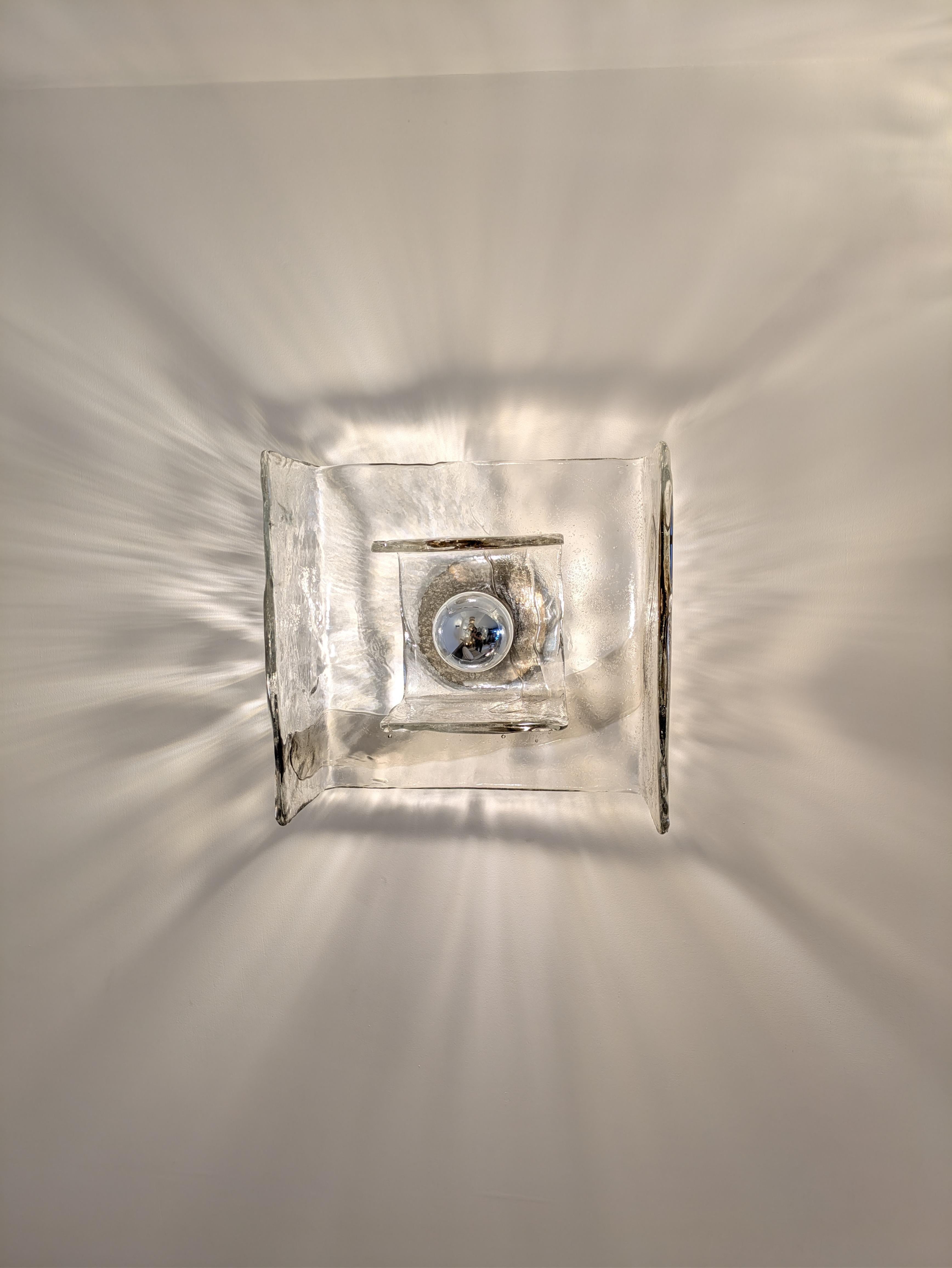 Kalmar Franked KG wall or ceiling light designed by Carlo Nason in the 1970's 
The fixture is in brushed cast iron. The glass has some brown colour mixed with clear glass.

Dimensions : 
H : 27cm
W : 28cm
D : 17cm

You have a large-scale project