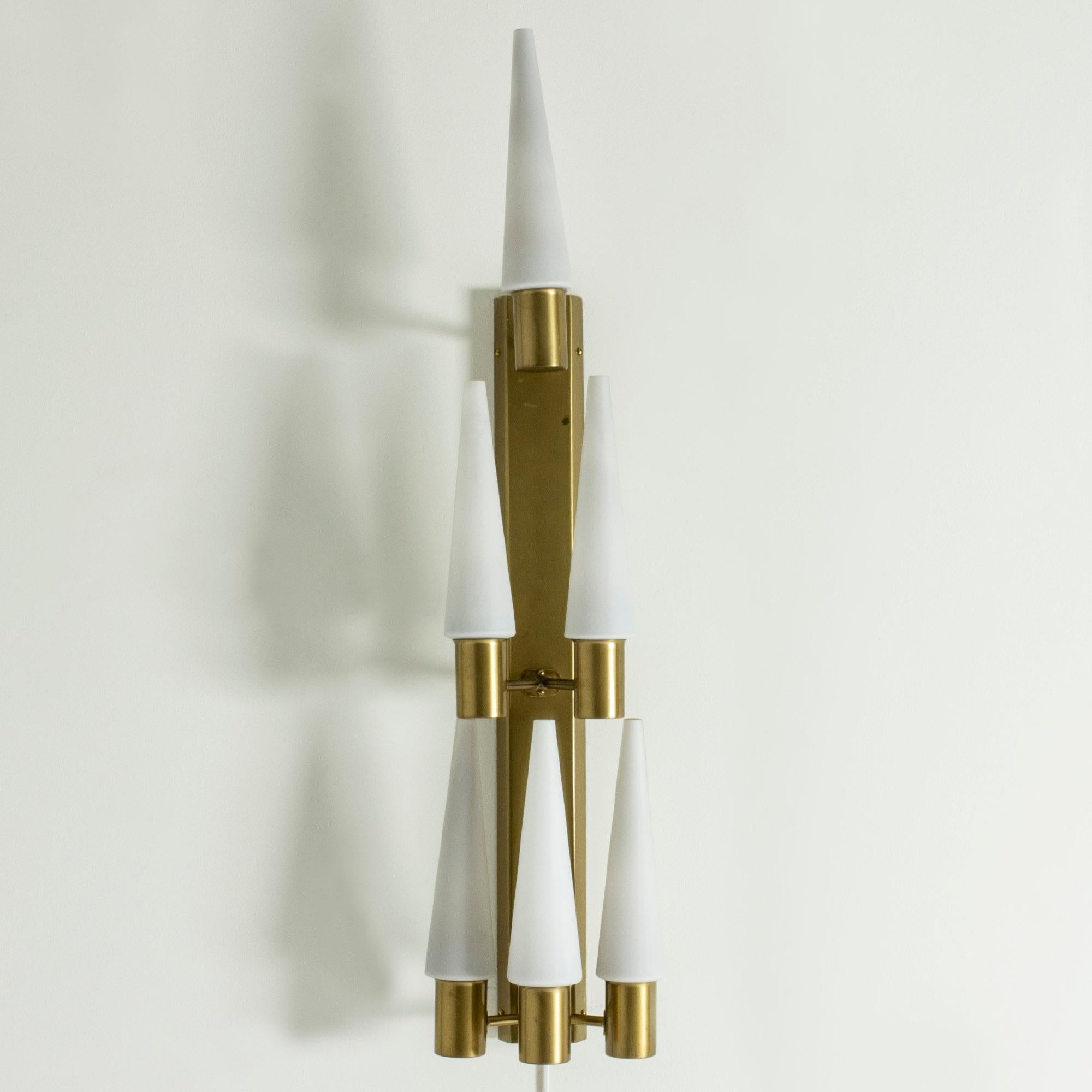 Amazing wall chandelier by Hans-Agne Jakobsson, made in brass with opaline glass shades. Slender, tapering shades in a very cool design. Beautiful, warm sheen when lit.