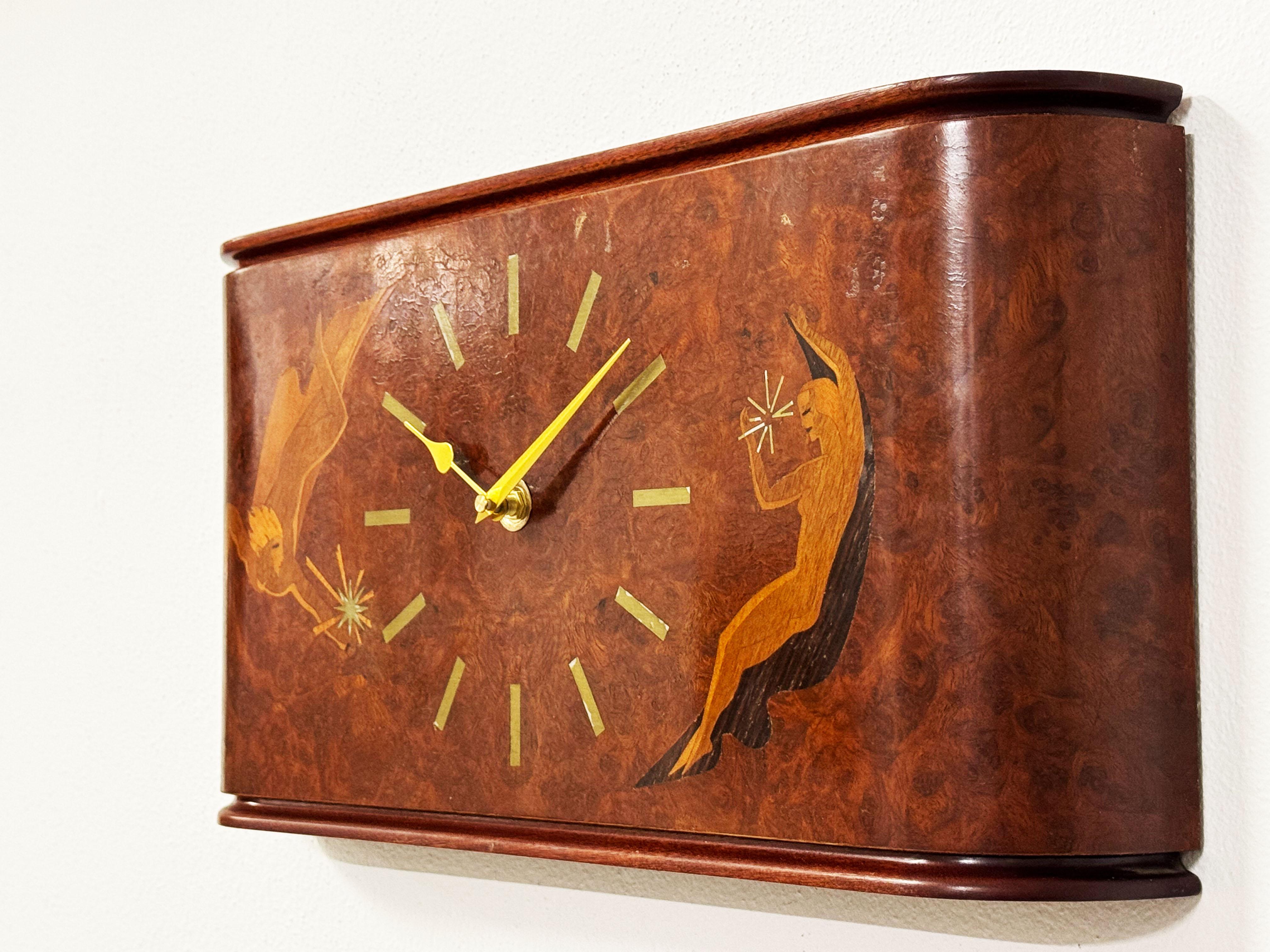 An original handcrafted inlaid Swedish wall clock attributed to Mjolby Intarsia. New battery movement.