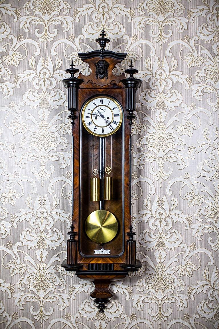 Late-19th Century Gustav Becker / Freiburg Wall Clock with Brass Elements

We present you a wall clock from the Gustav Becker - Freiburg manufactory (today’s Świebodzice, Lower Silesia) in an Eclectic wooden case.
The face is porcelain, with Roman