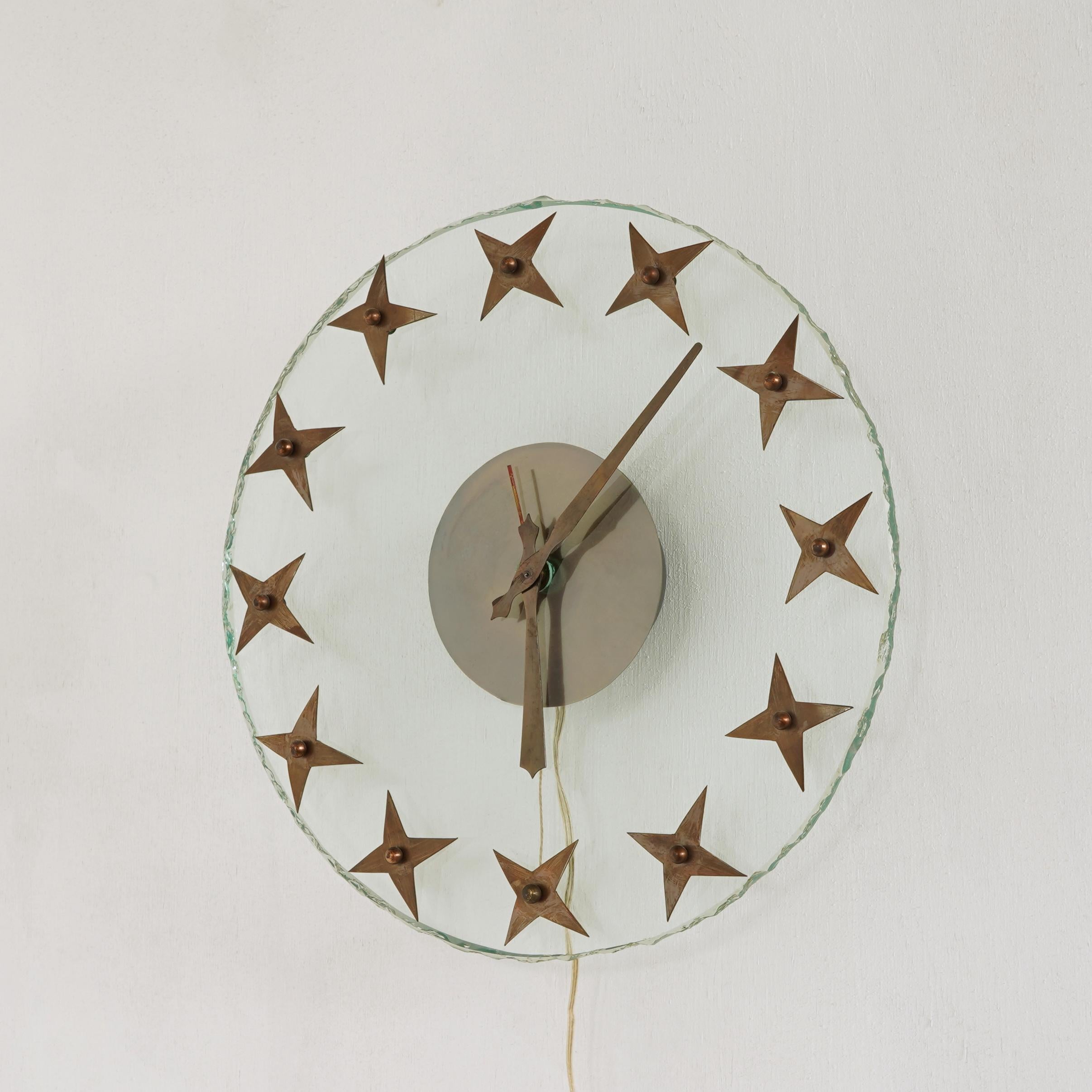 Beautifully detailed electric wall clock in glass and brass. Probably made in the 1940’s.

This thick and large glass wall clock is refined yet robust and the green glass has beautiful rough carved edges. The hours are represented by handmade brass