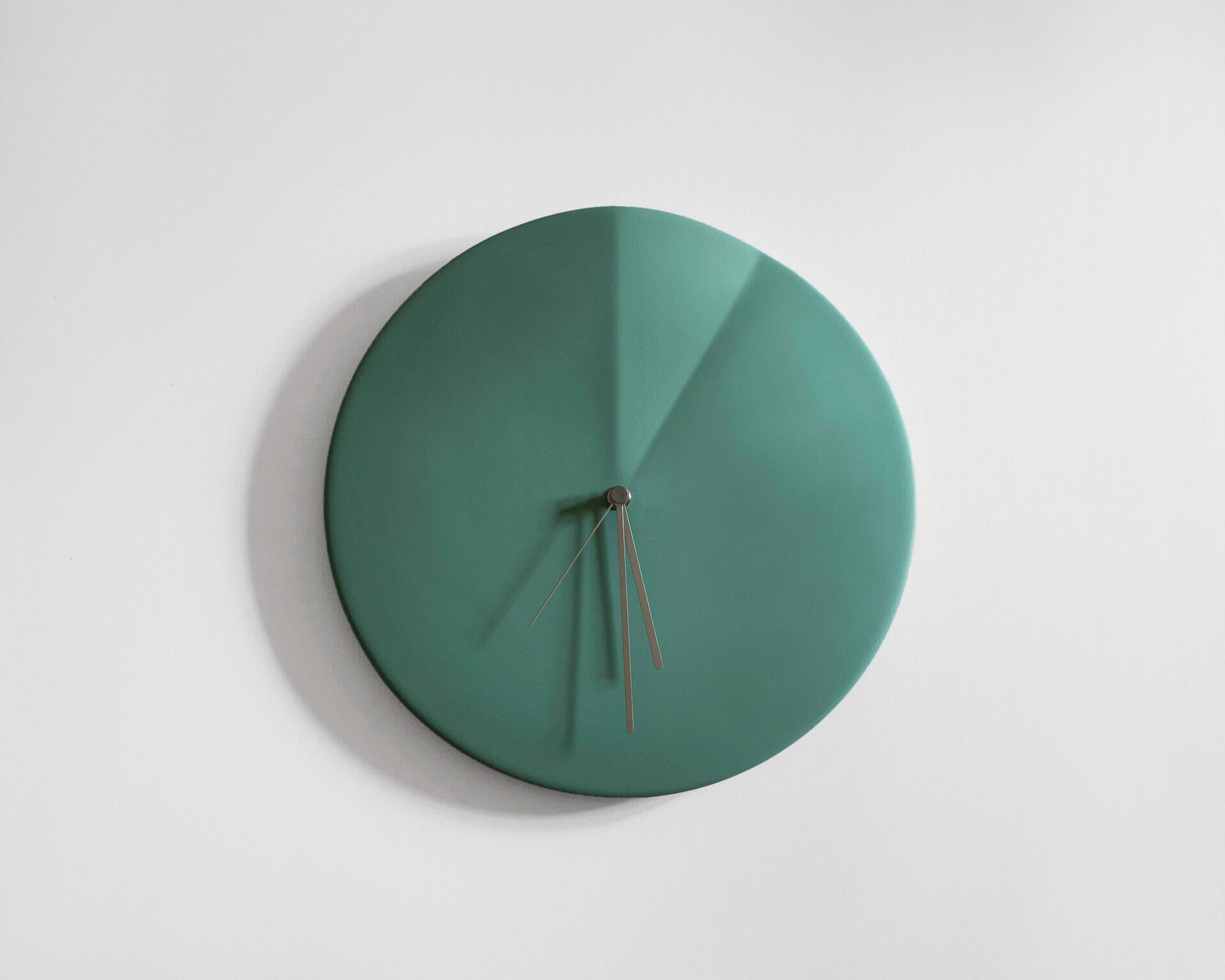 Oree
Wall clock signed by Ocrùm 

Dimensions: 11.75 x 1.5 in
Materials: Painted ceramic, aluminum hands
Colors: 
Cream White / Wine Red / Light Blue / Granite Blue / Light Grey / Antique Pink 
Hands: Copper / Grey
Movement:
Silent