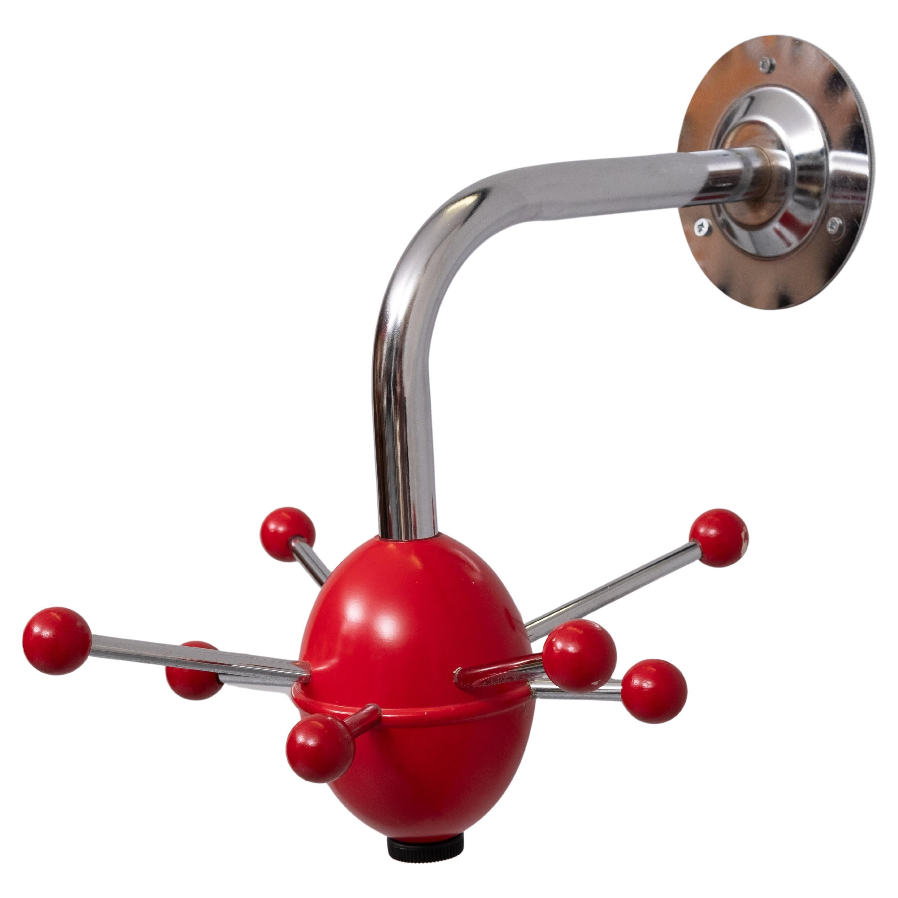 Red sputnik atomic coat rack, coat hanger,  1990s, retro space age design. 8 hooks .Wooden revolving base .

This coat hanger is often credited to Osvaldi Borsani for Techno Italy.
There is a similar design from the Ikea, in the 1990s Mina