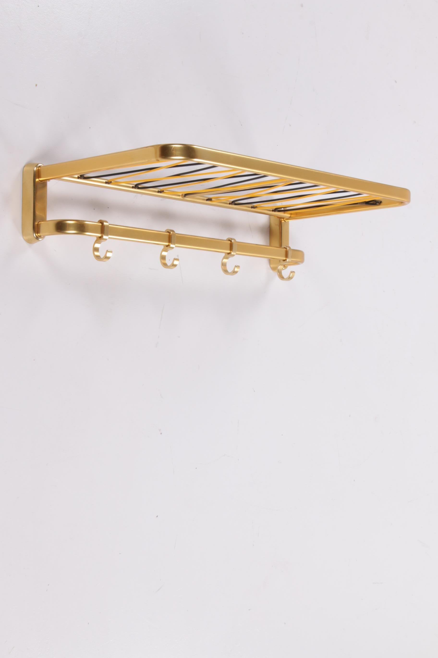 Wall coat rack Hollywood Regency style 1960s


Gold-coloured aluminum coat rack from Germany.

There is an extra rack under the top rack.

Probably made in the 1960s, now completely hip again.

Some discoloration in some places, which is not unusual