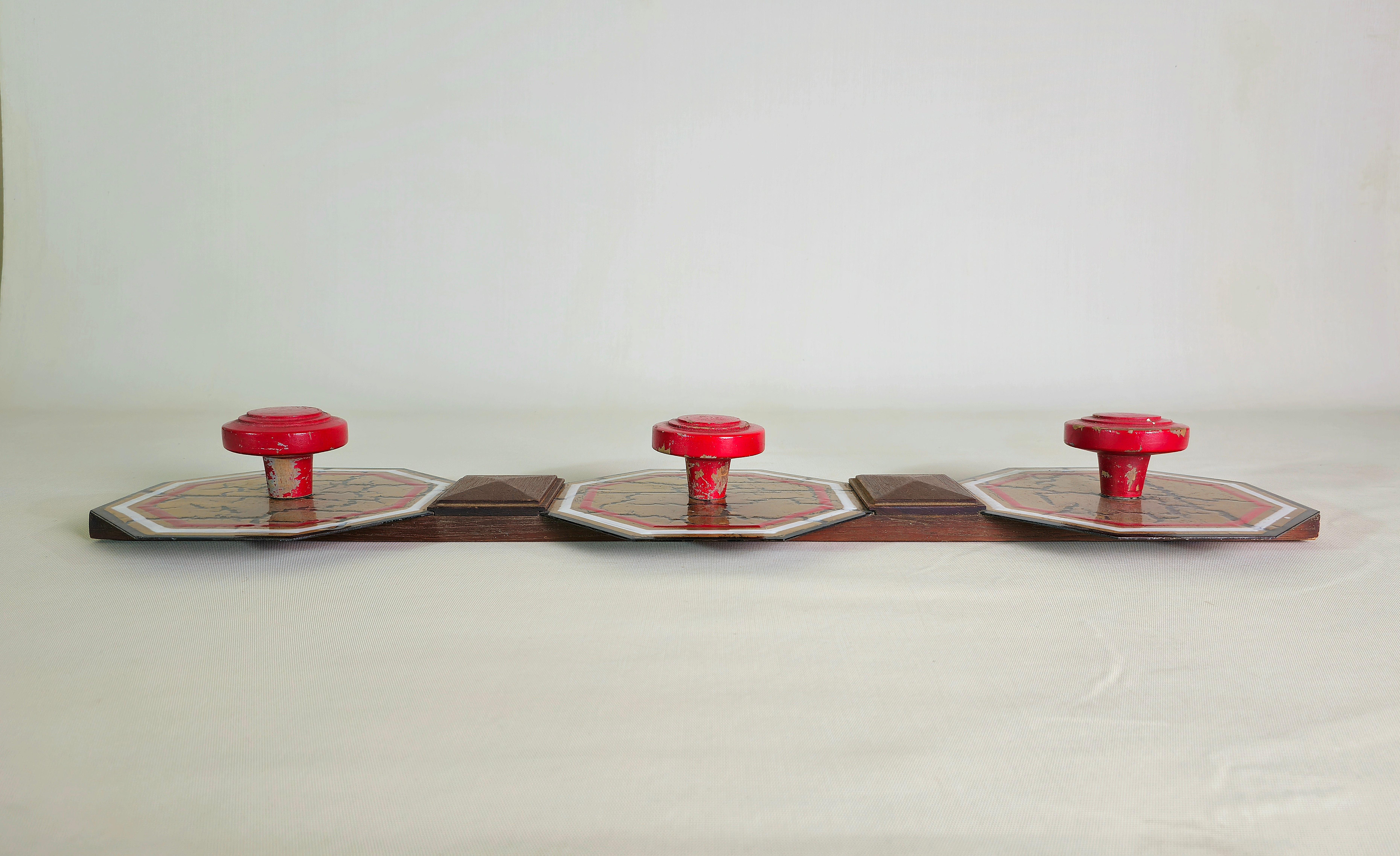 Wall coat hanger made with red enamelled wooden knobs, teak structure and 3 hexagonal plates in multicolored decorated metal with a particular shiny effect. Italy of the 60's/70's.


Note: We try to offer our customers an excellent service even in