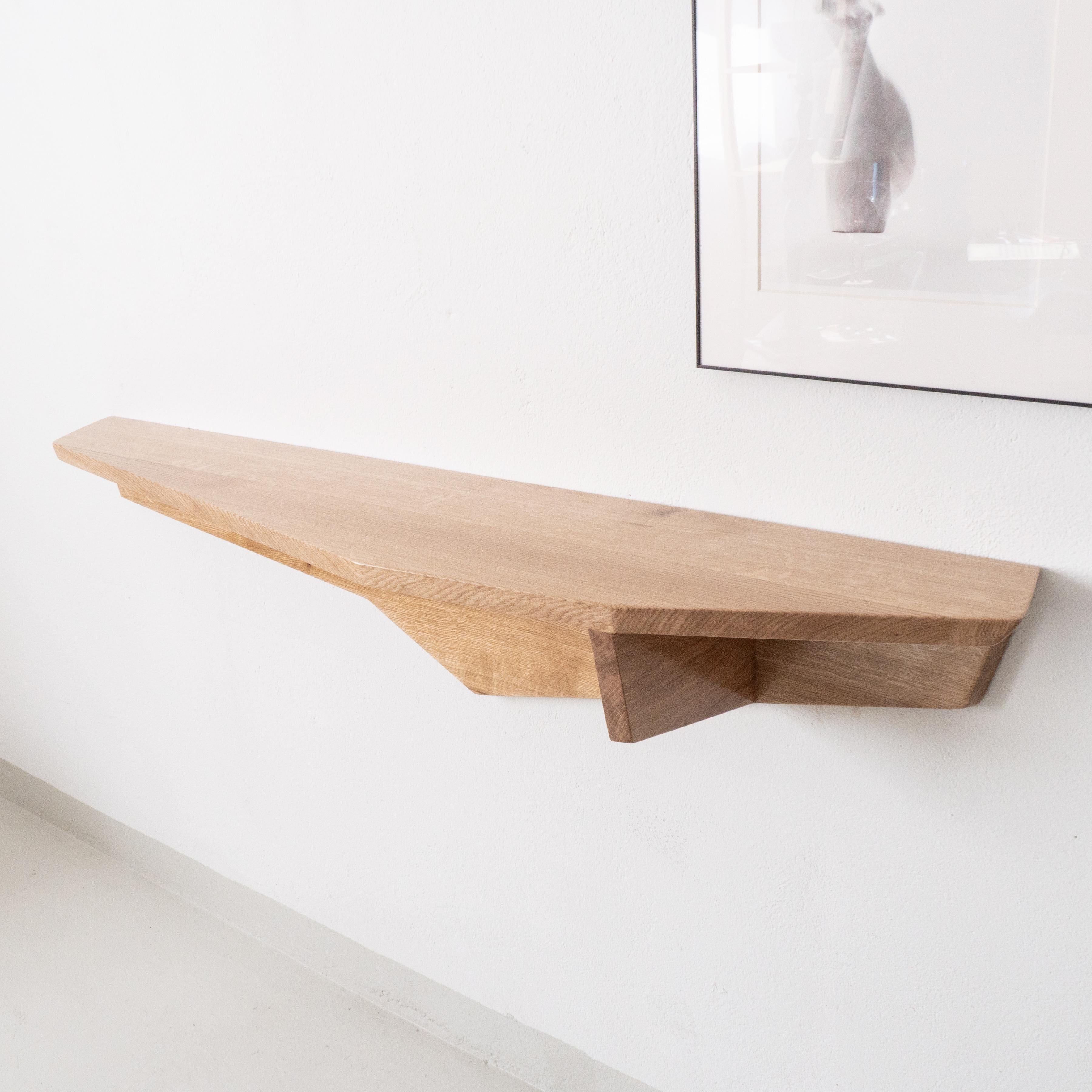 A unique hand-sculpted wall console in solid oak. 