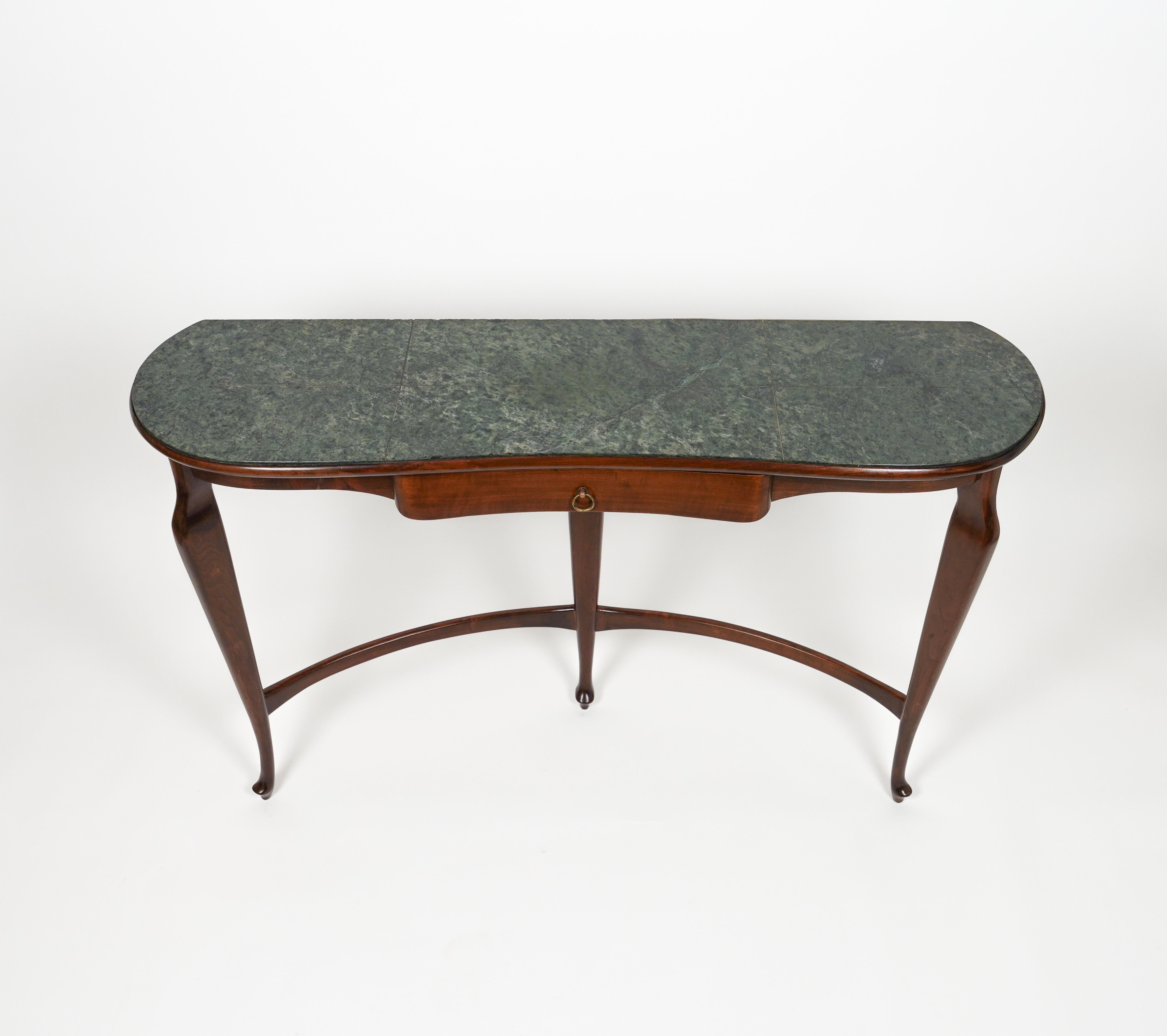 A very elegant and organic wall mount console table, green marble top, wooden frame, tapered legs attributed to Italian design by to Guglielmo Ulrich.

Made in Italy in the 1940s.

Wood has been polished by a professional restorer.