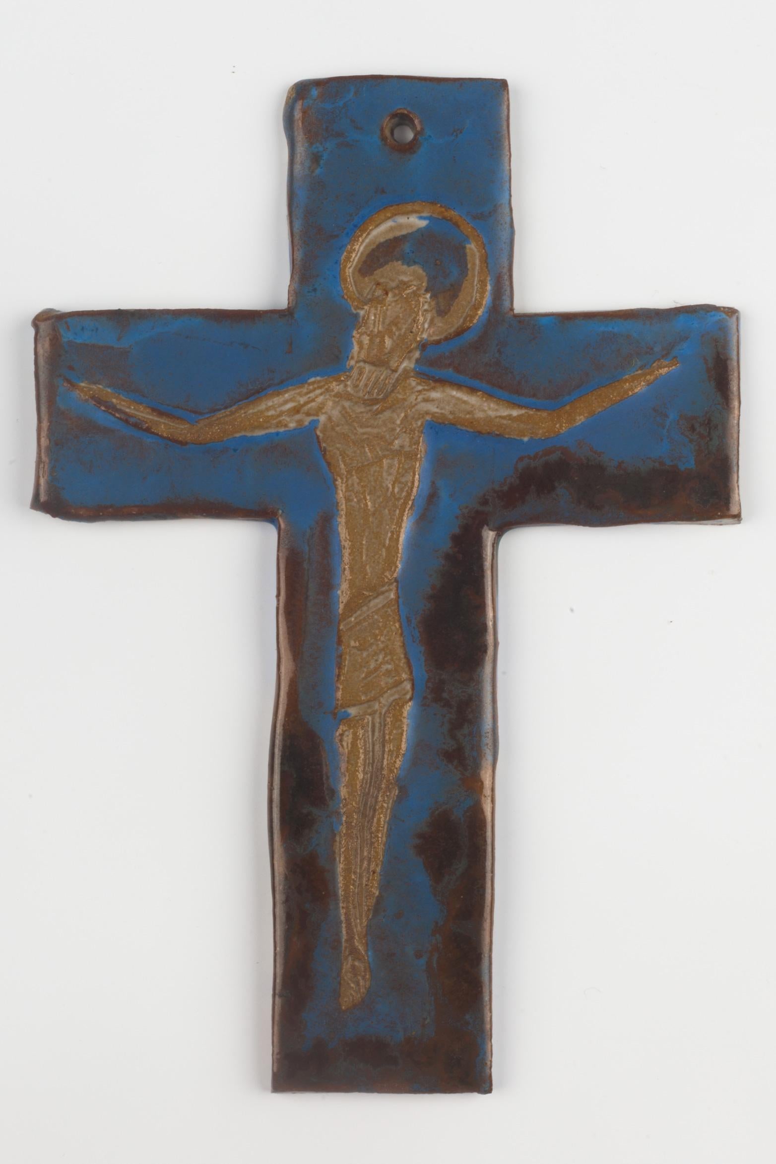 Ceramic, handmade wall crucifix in ceramic with a stone like texture. Artisan made in Belgium in the 1960s. Beautiful color balance with light brown Christ figure floating over blue and dark brown cross. 

From modernism to brutalism, the crosses