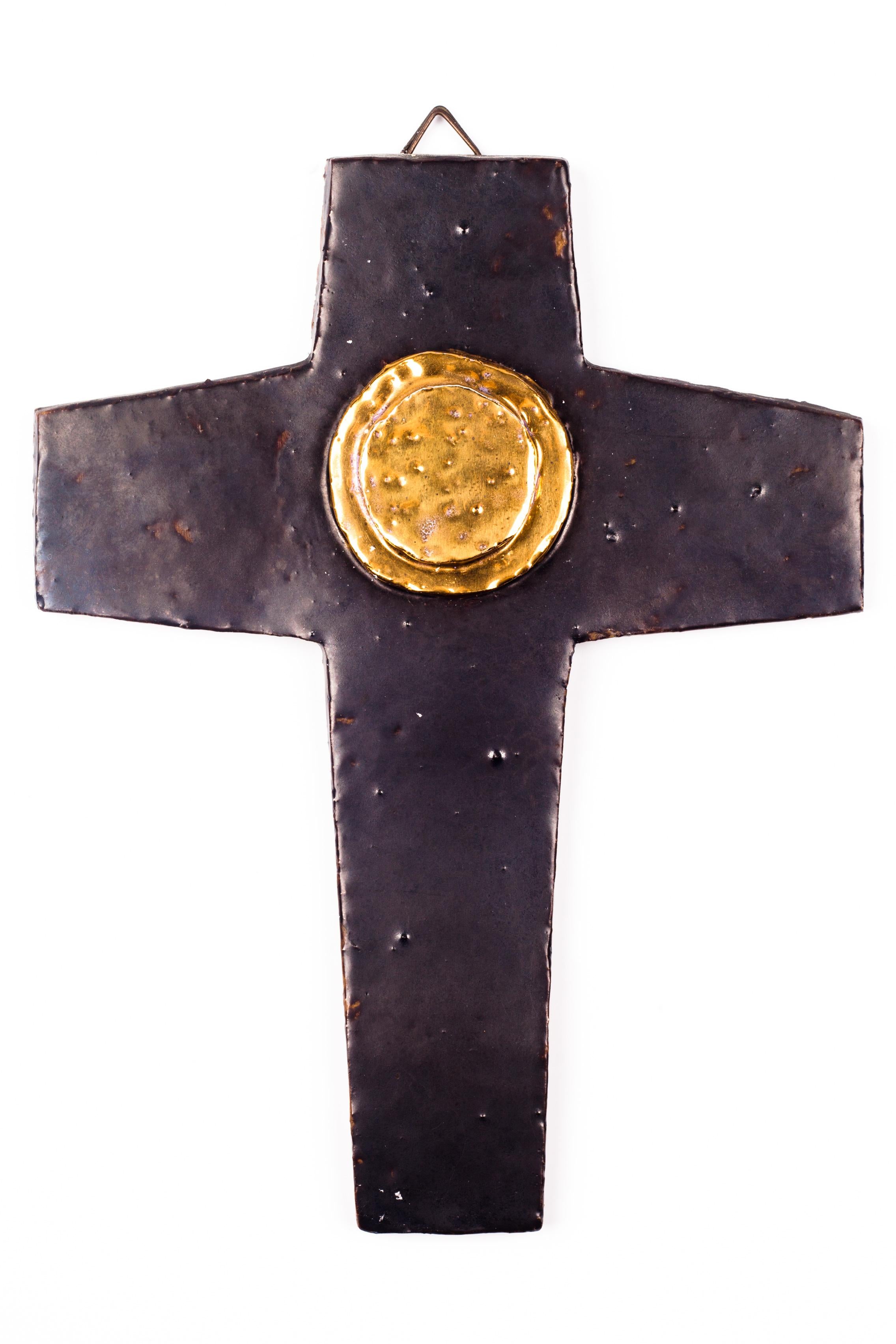 Wall cross with matte brown finish and glazed gold painted medallion at centre. This is a handmade one-of-a-kind piece that was part of a large collection of Belgian crosses made by artisan potters in the 1950s-1970s. An unique decorative item for