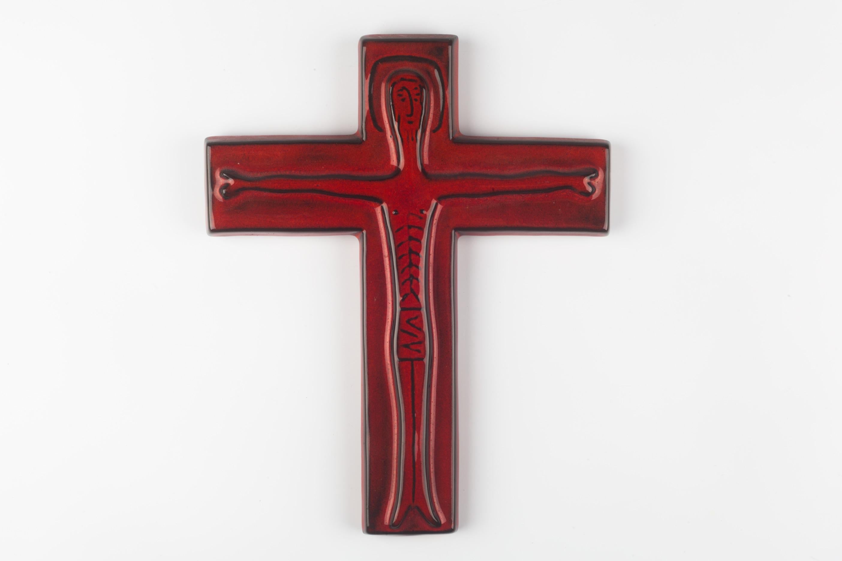 Handmade ceramic wall cross, artisan made in Belgium in the 1960s. Hand-painted in deep red with black contours. Finished in high-gloss glaze. Original and modern interpretation of the Christ figure that can easily be re-imagined as one of today's