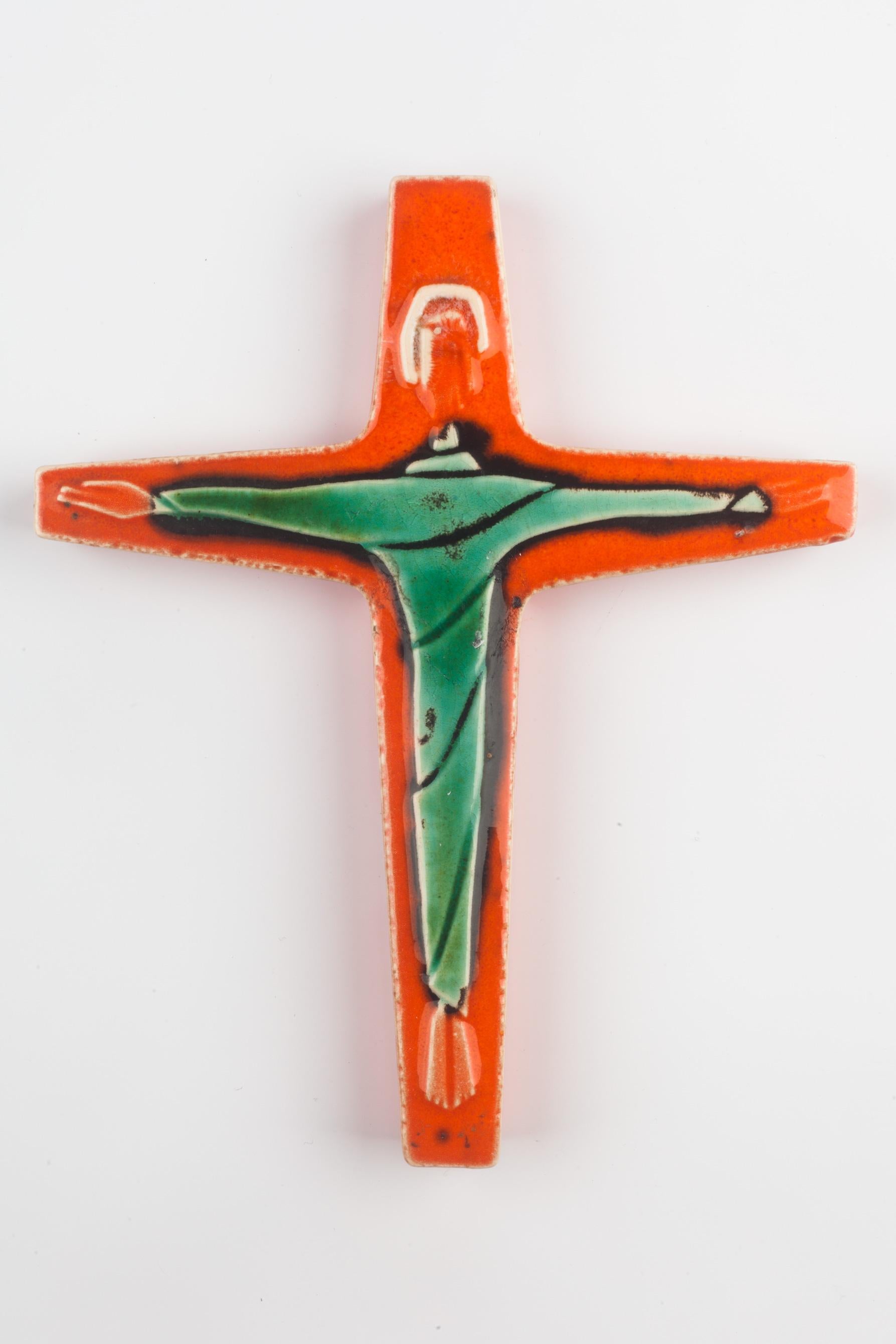 Ceramic handmade crucifix, artisan-made in Belgium in the 1960s. Glossy green and orange Christ over bright orange cross gives this piece a striking color balance. 

From modernism to brutalism, the crosses in our collection range from being as