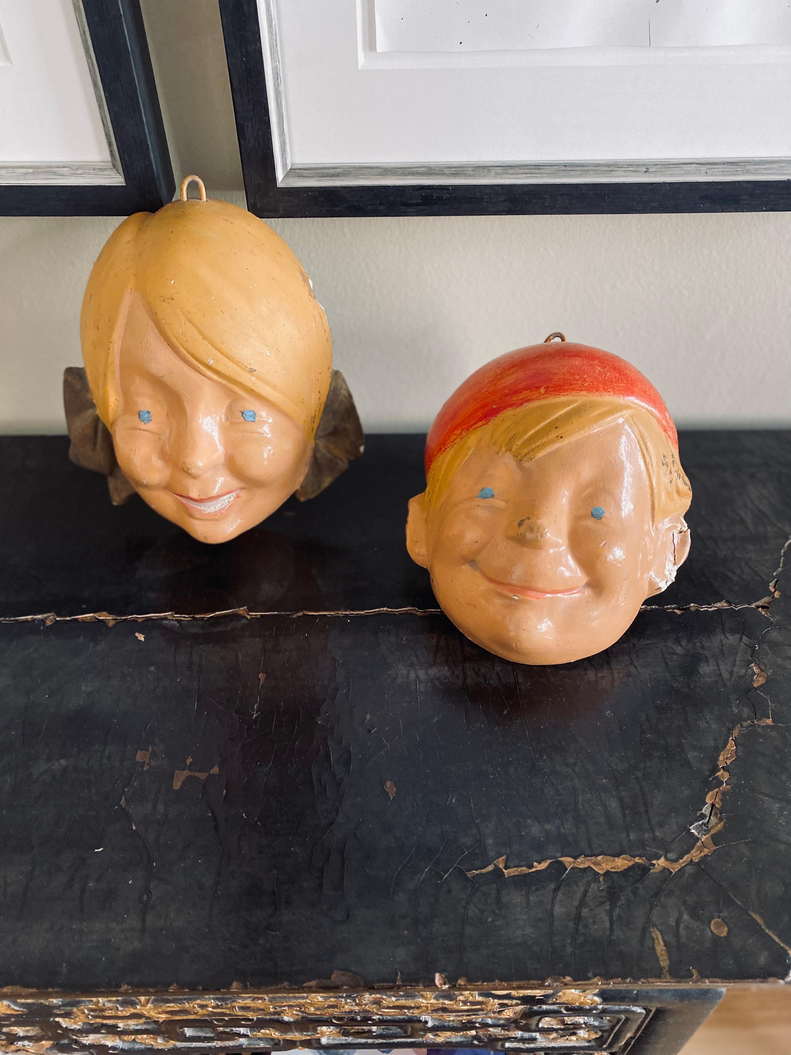 If that isn't an unusual wall decoration for a child's room or a children's shop. The heads are painted plaster casts. The heads were not originally intended as wall decorations but must have served as a model form on which to make masks for