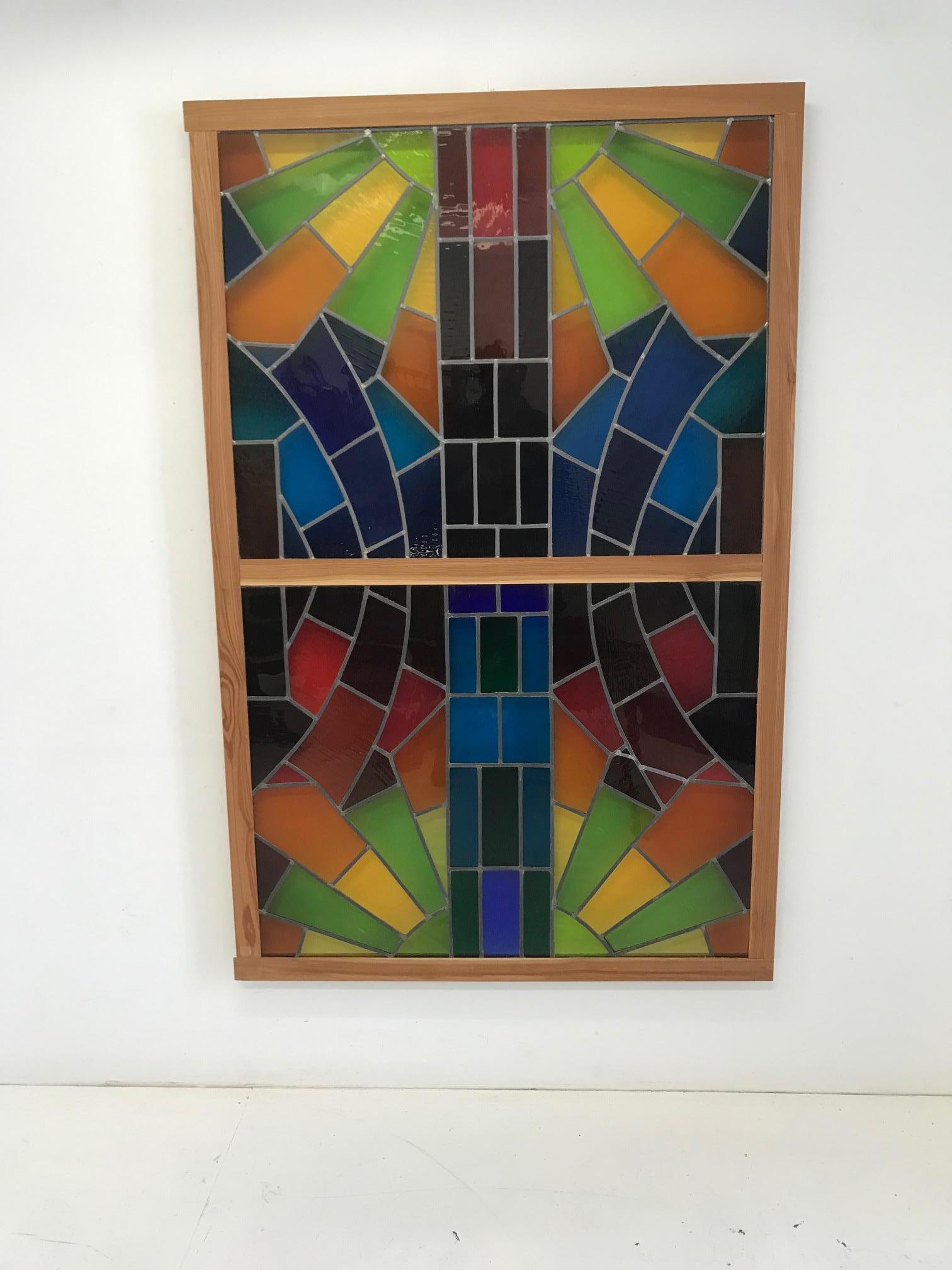 Large stained glass window with geometric multi-color patterns.
The panel consists of 2 pieces mounted on a wooden frame
Tin technique, tiffany
In a perfect state, never installed.
