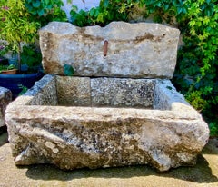 Wall fountain created from reclaimed old stone elements