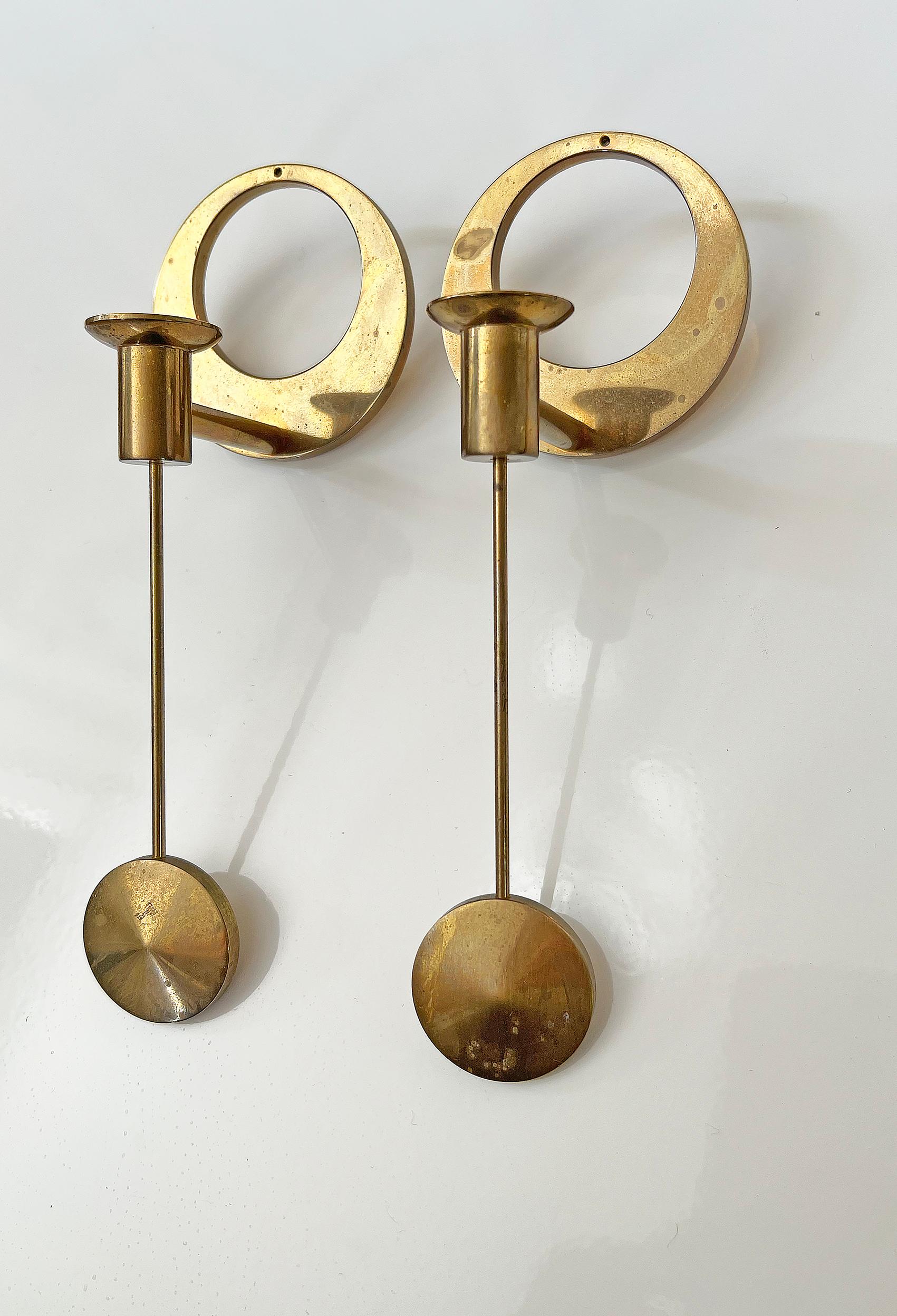 Beautiful wall hanged candlesticks in brass, designed by Arthur Pe ca 1950's. 
Produced by his own studio Kolbäck in Sweden.
Signed with makers mark.
Good vintage condition, wear and patina consistent with age and use. 
Brass patina and small rust