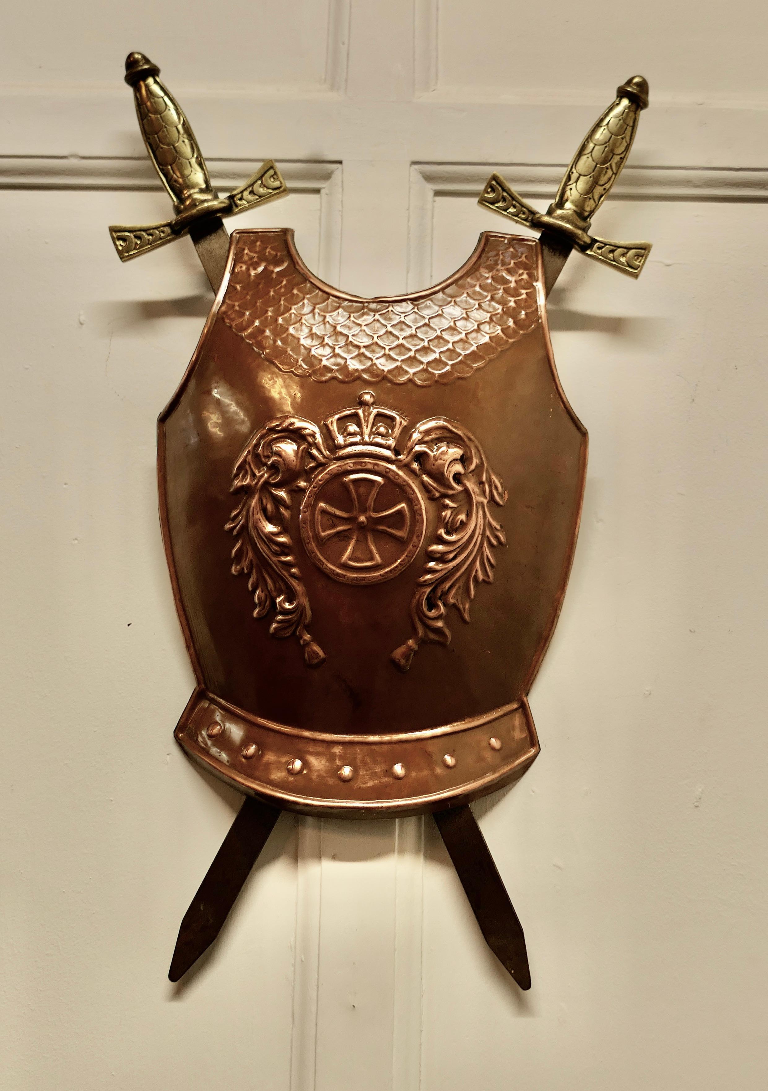Wall hanging Arts and Crafts copper breast plate shield with cross swords 

A Large Decorative wall piece the copper is hand beaten and has a Cross with Crown over
The swords are held in the back but not removable, a good looking piece of