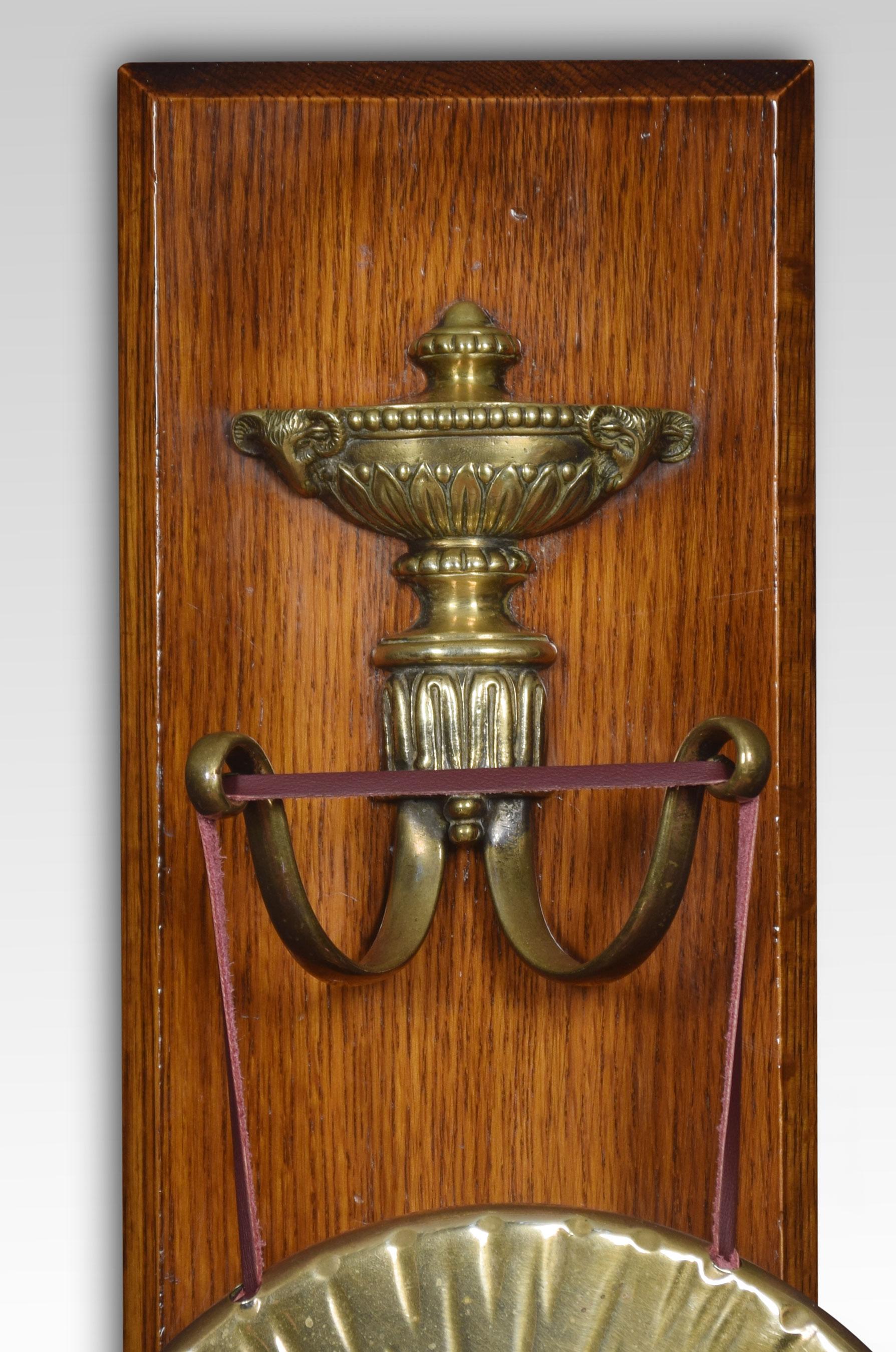 Wall hanging dinner gong, the oak backplate with brass urn decoration above scrolling hooks supporting the circular gong. Together with original hammer.
Dimensions
Height 15.5 inches
Width 7 inches
Depth 3 inches.