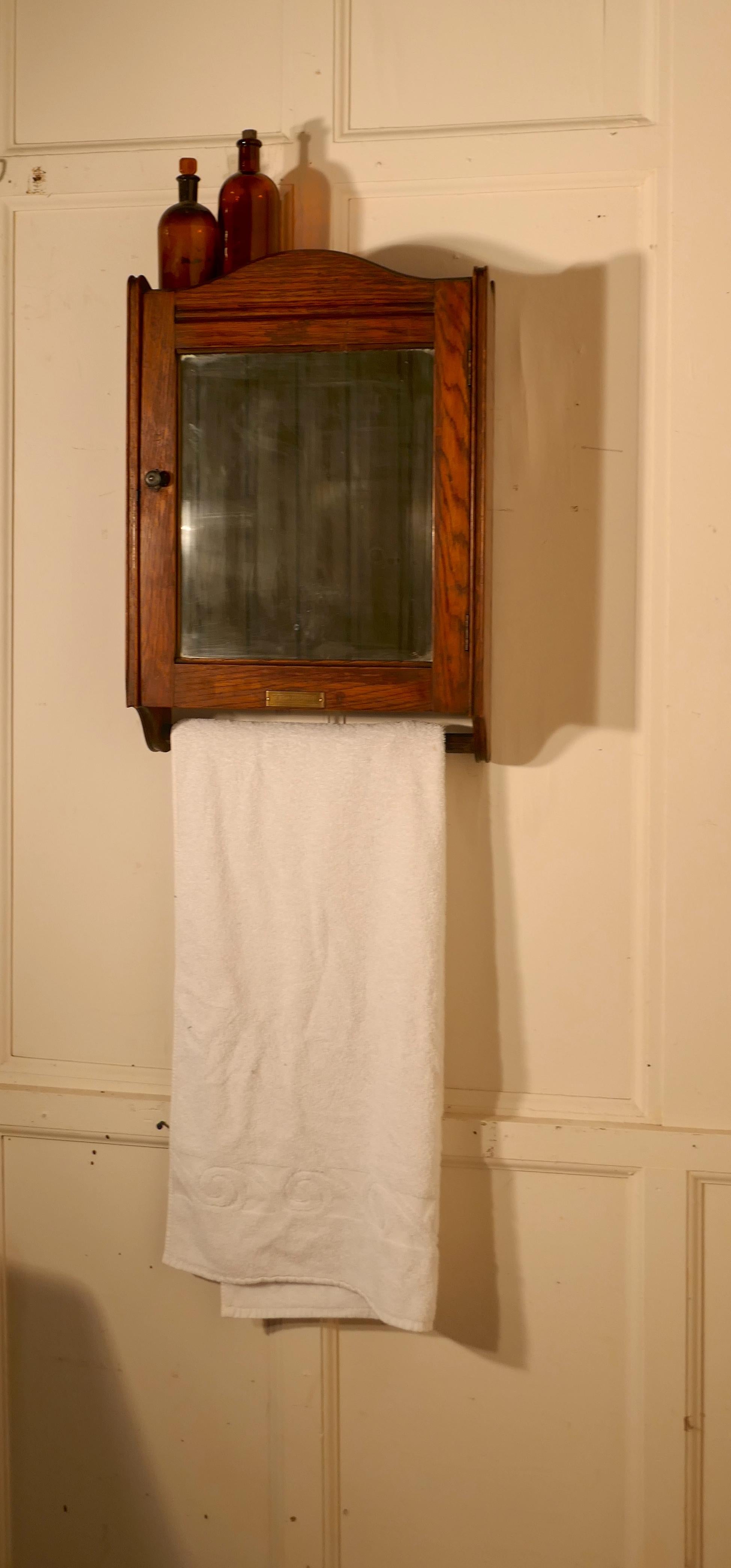 Wall hanging oak cloakroom or bathroom cupboard from the Initial Towel Supply Co. 


A very useful bathroom cabinet this wall hung shelved cupboard has mirrored door and a towel rail below and a brass plaque at the bottom of a little historical