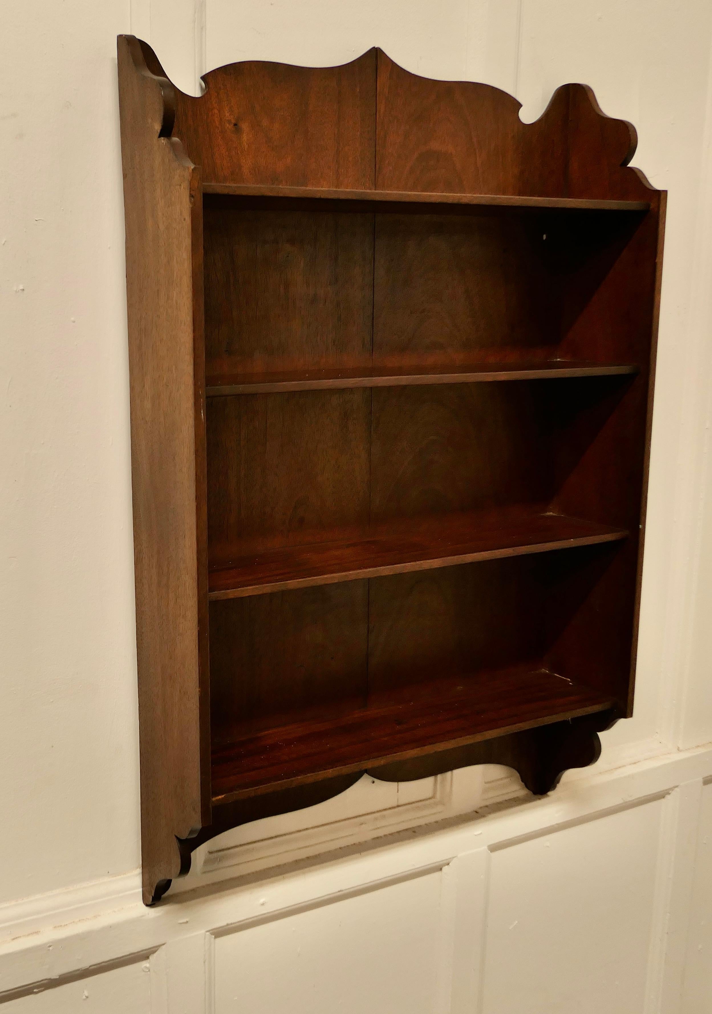 Wall hanging shelf.

This charming little shelf unit has a solid back, the shelf has a scalloped top and bottom edge and there are 4 shelves.

The shelf is in good condition and would work well in many room designs 
The shelf is 16.5” deep, 29”