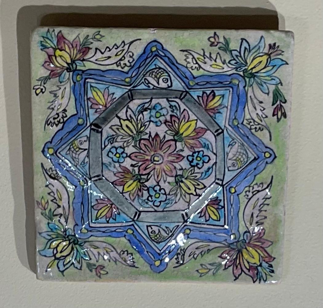 Vintage wall hanging Persian ceramic tile, Hand painted and glazed in multicolour floral and geometric motifs.