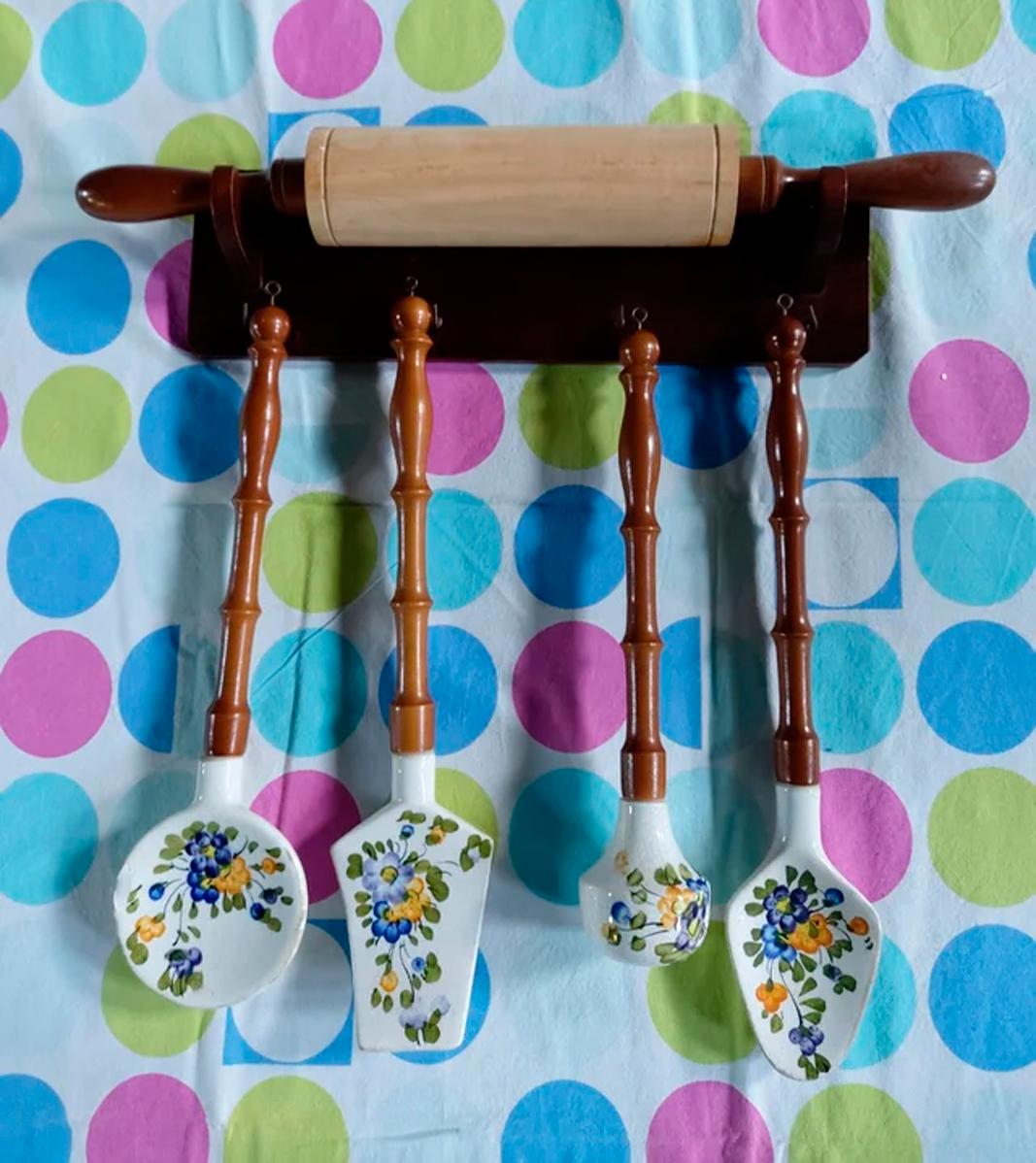 Italian Old kitchen tools or utensils made of wood and ceramin hanging from a hanging bar. Old kitchen appliance  

Saucepan fork palette and serving pot mace and roller hanging on top

This set of wood and ceramin utensils is ideal to decorate a
