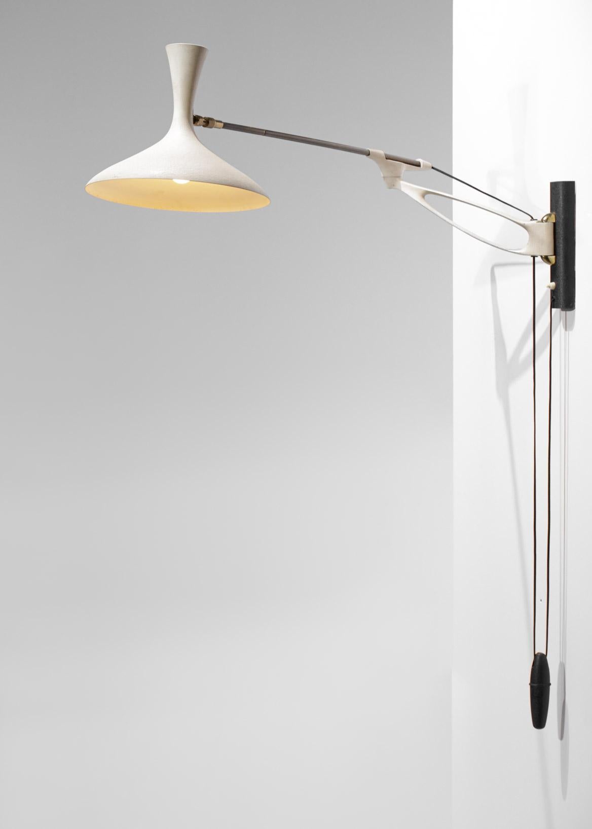 German telescopic lamp from the 50's by the designer Cosack Leutchen. The arm, counterweight and shade are made of black or beige lacquered metal. The system of counterweight and pulley allows to modulate the length of the gallows, possibility to