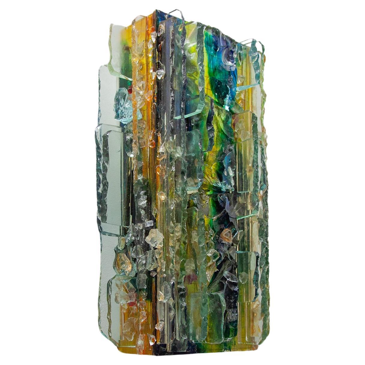 The Dutch glass artist Willem van Oyen produced this kind of lamps individually, by hand, in his BEVO Glas Industrie workshop. All are each slightly in different colors green, yellow blue and clear hand-cutted glass. First produced in 1964, the