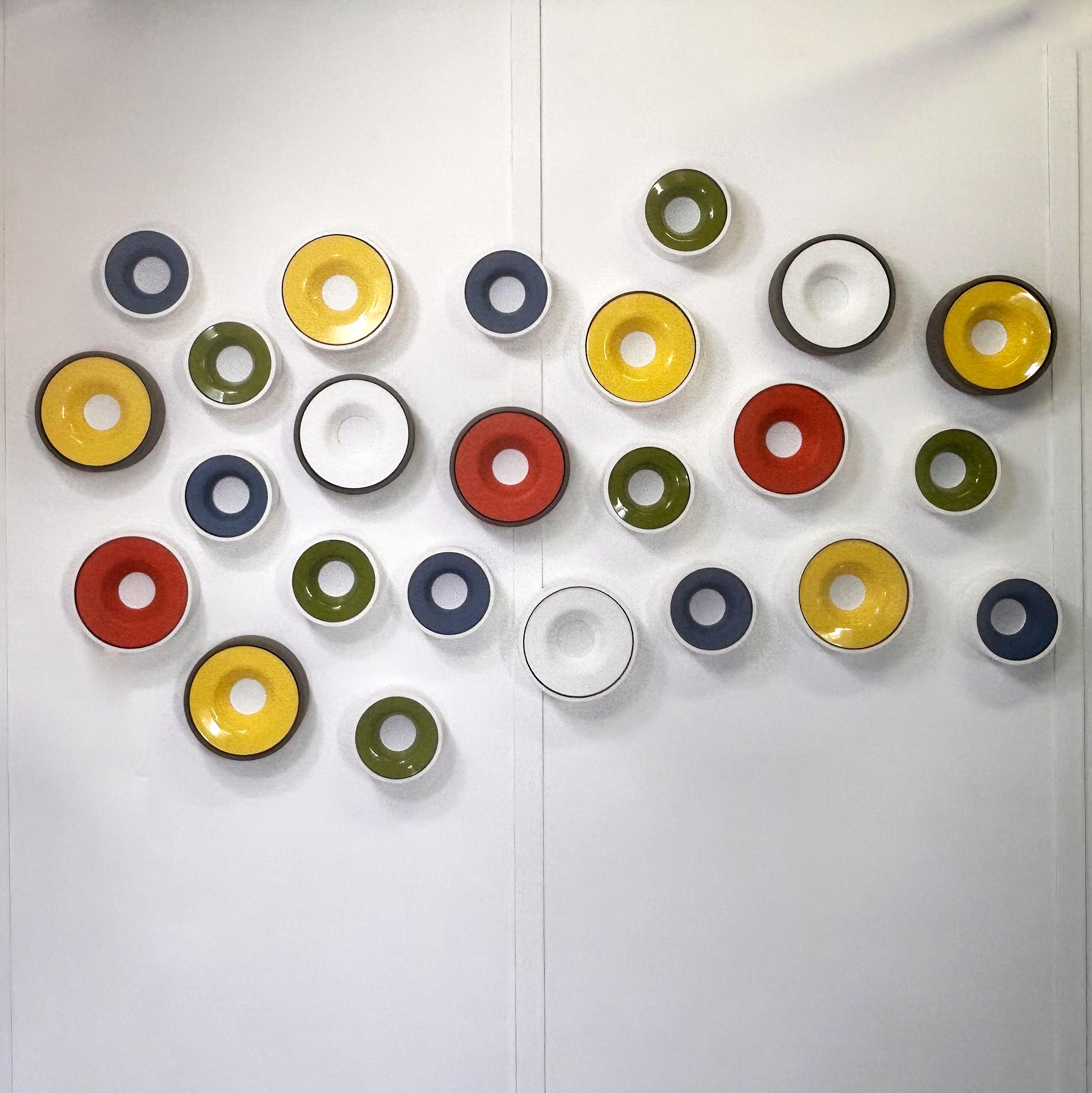 A visual experience that transcends mere illumination. This composition of 24 luminous elements, created in 2022, manifests as a dynamic art installation, a dialogue between light, form, and color. Each 'disk' is a fragment of a visual orchestra,