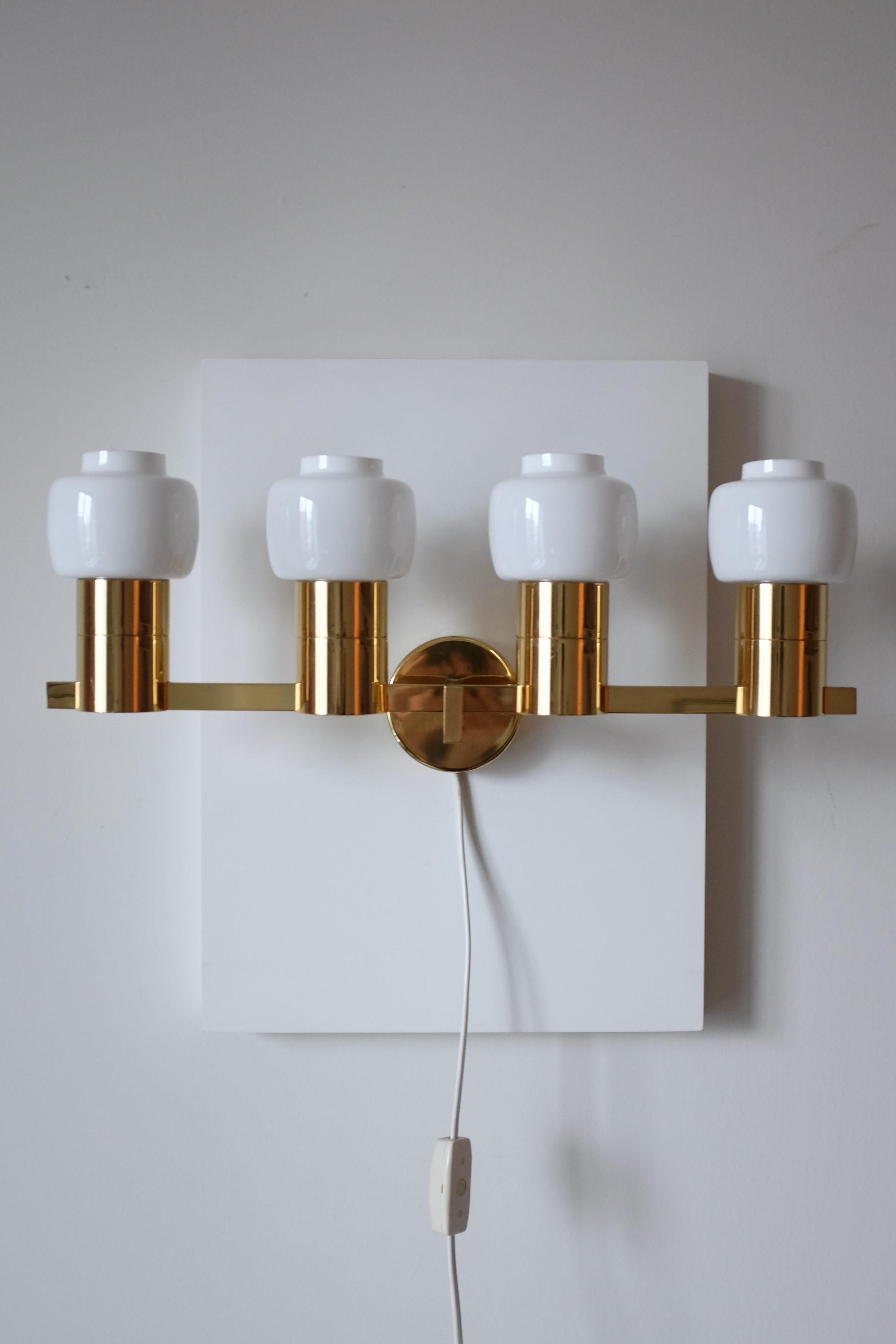 Stunning Vintage Wall Lamp Model V-306/4 by Hans-Agne Jakobsson for his eponymous light firm in Sweden. This piece have 4 lamp arms both with a milky white lamp lanterns with labels attached. In great vintage condition with few signs of wear to the