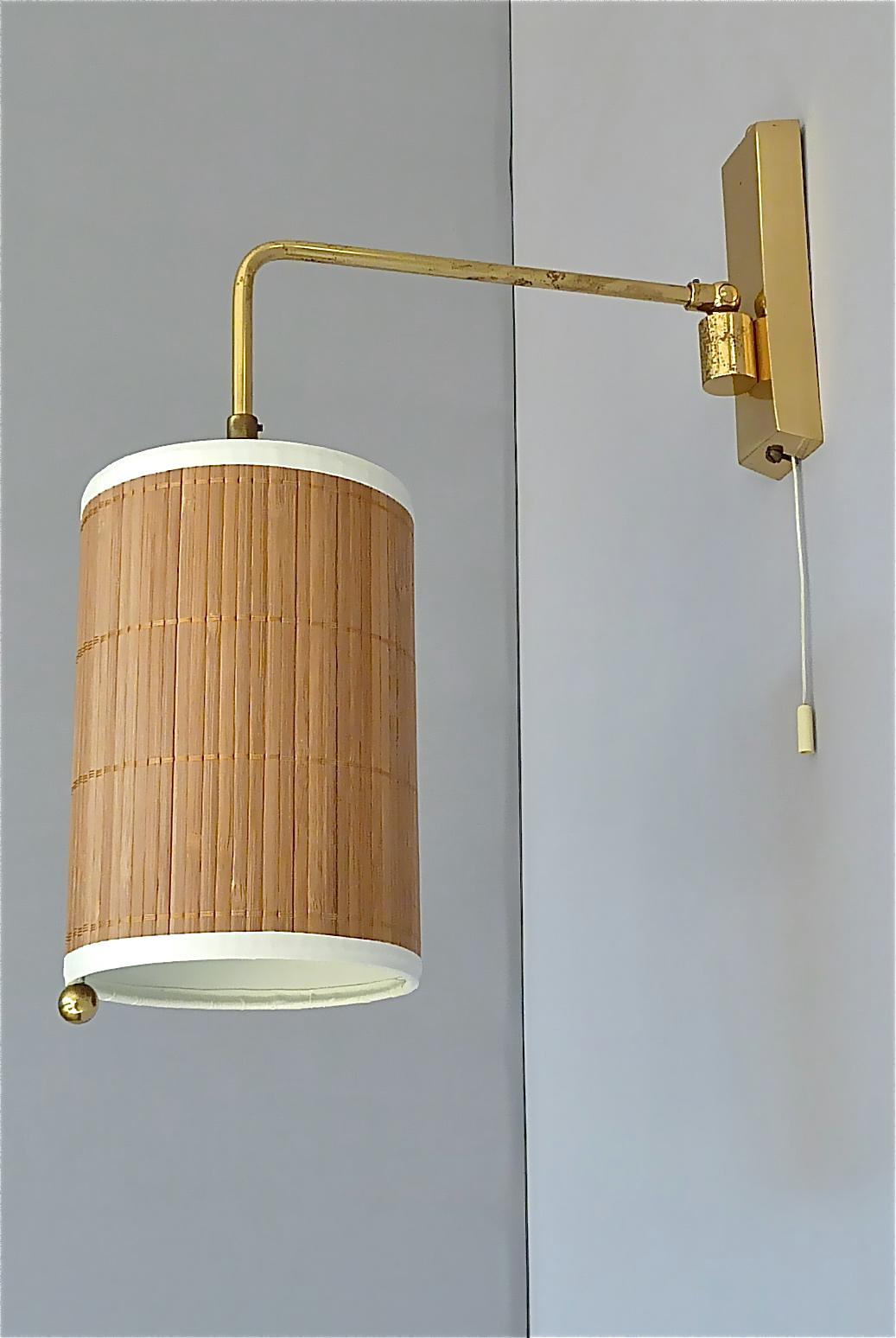 Amazing Scandinavian / Austrian wall lamp in Paavo Tynell Taito Oy / Kalmar style, circa 1955. The height and side adjustable wall lamp with string switch has a solid patinated brass base with movable arm for multiple light positions and a beautiful