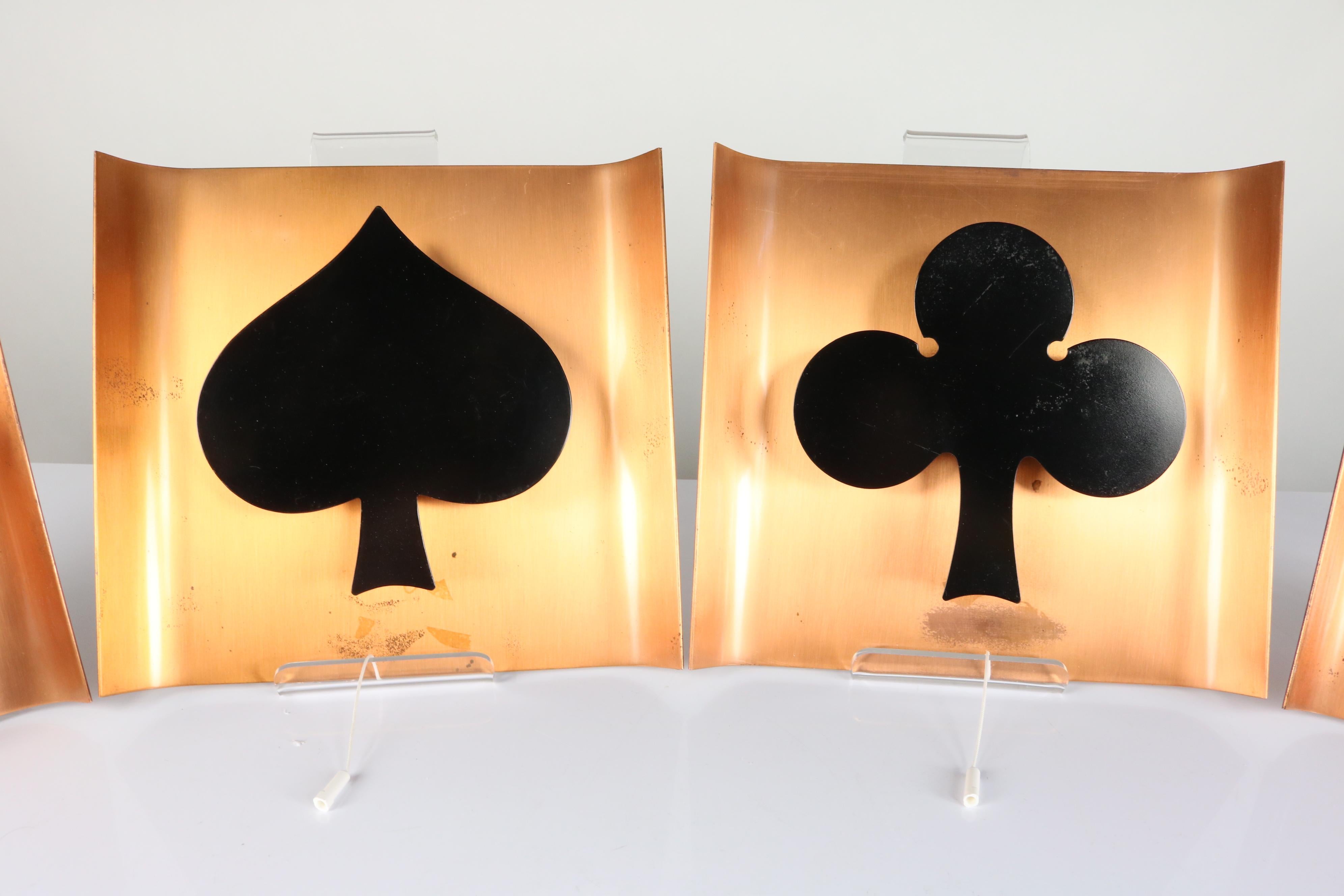 A set of four wall lamps with playing card symbols
made of copper and steel by Kaiser Leuchten Germany in the early 1960s
each lamp is equipped with a pull switch
good used condition with signs of usage and age
you need a small Edison screw bulb