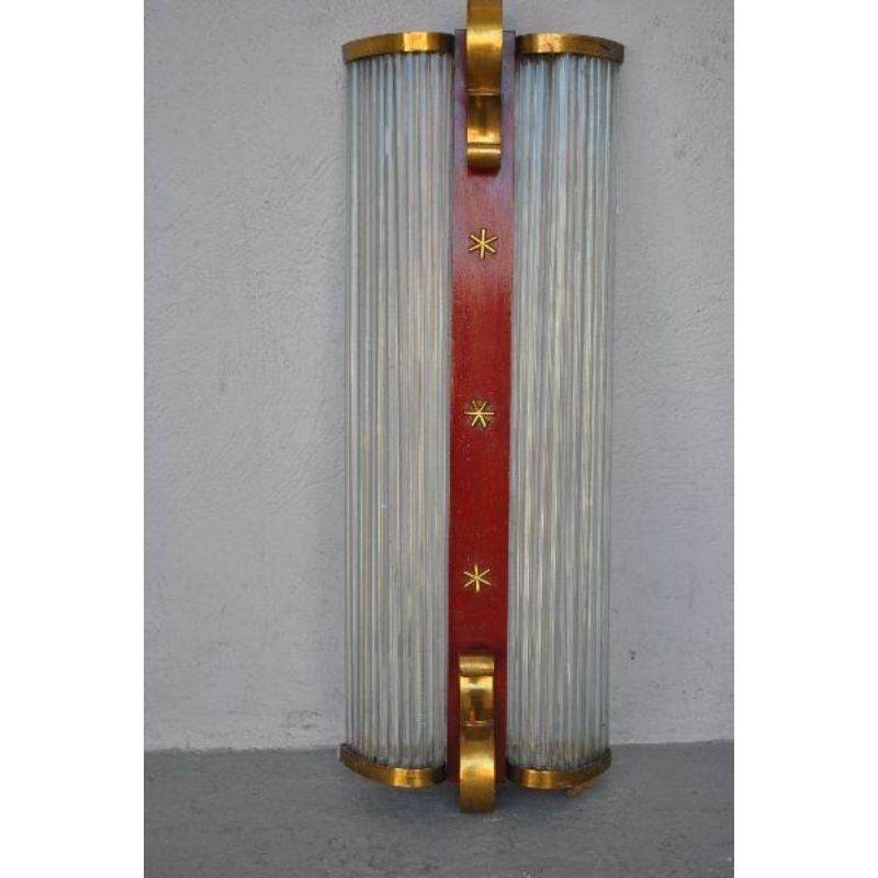 Light wall lamp from the 1950s with glass rods and red lacquer decorated with stars. Dimension height 68 cm for a width of 24 cm by 10 cm depth. Work in the spirit of Jacques Adnet

Additional information:
Style: 1940s to 1960s.