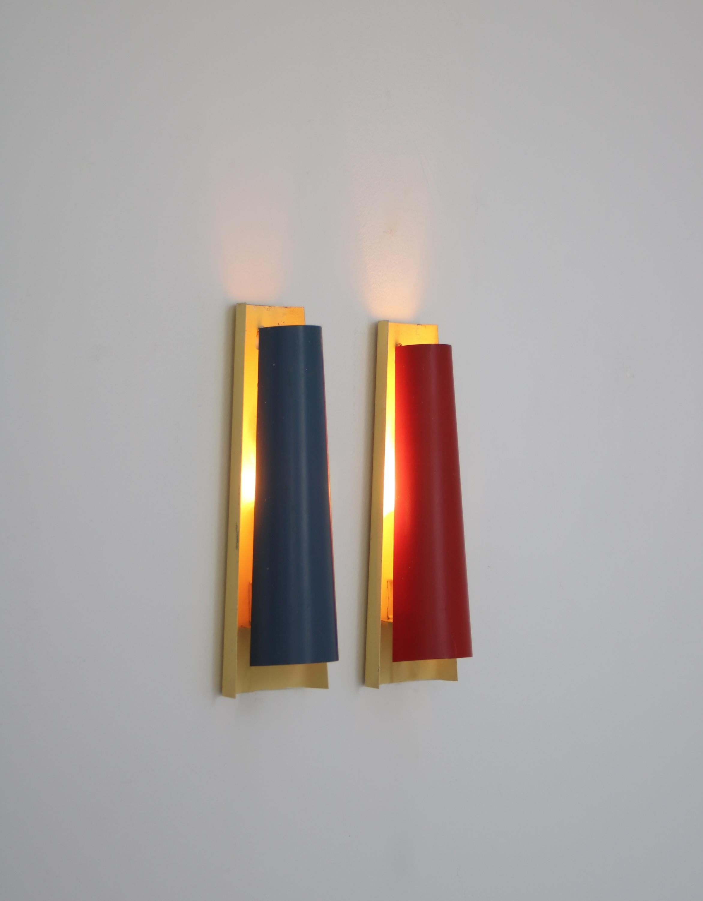 Rare pair of Danish Modern wall sconces designed in 1963 by Henning Wind-Hansen and manufactured at Voss Belysning (Voss Lighting). The sconces are made from lacquered metal plates. Marked by maker.