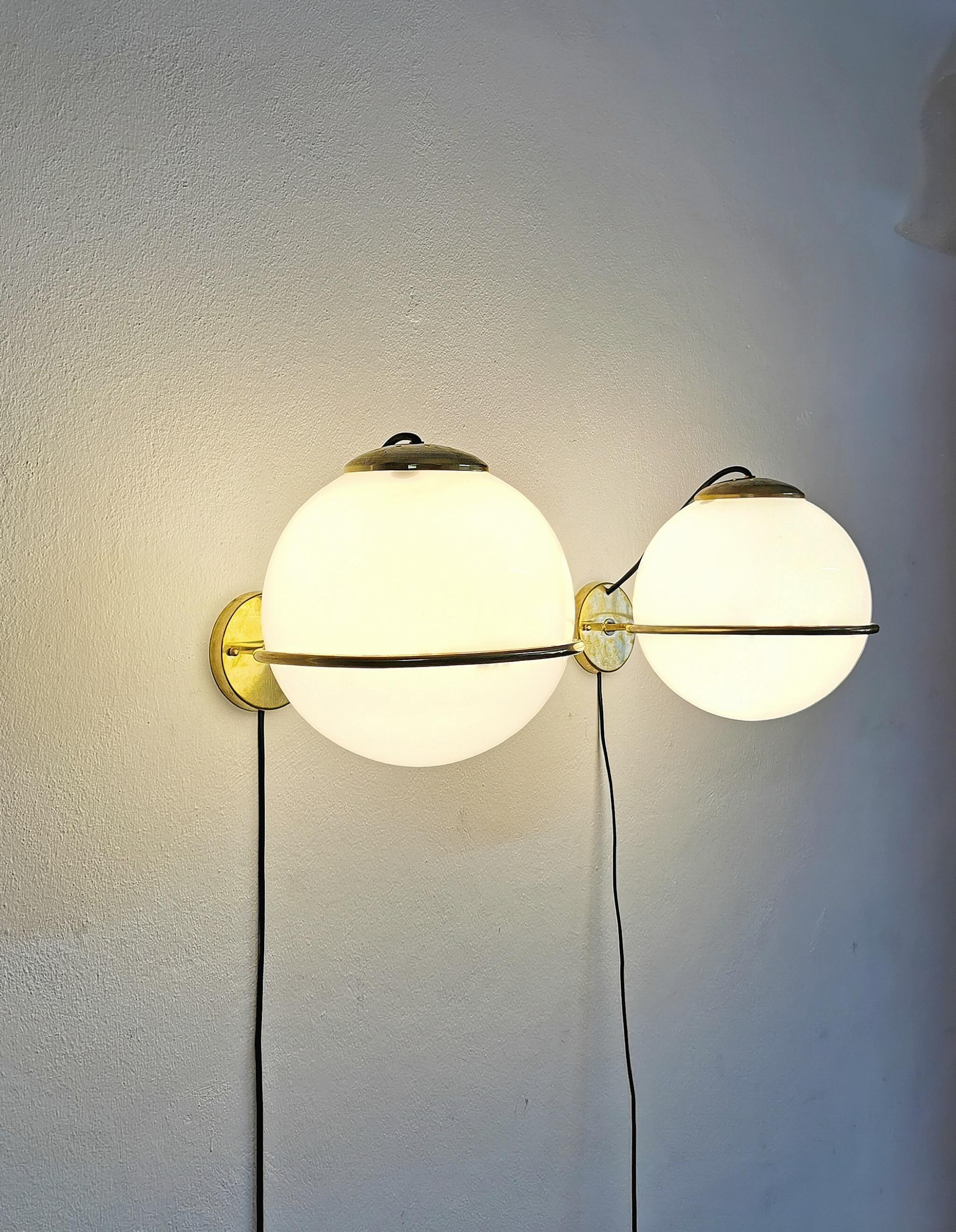 Particular and elegant set of 5 wall lamps with structure entirely in brass and spherical milk white glass diffusers with 1 E27 light. Italian production of the 1960s.