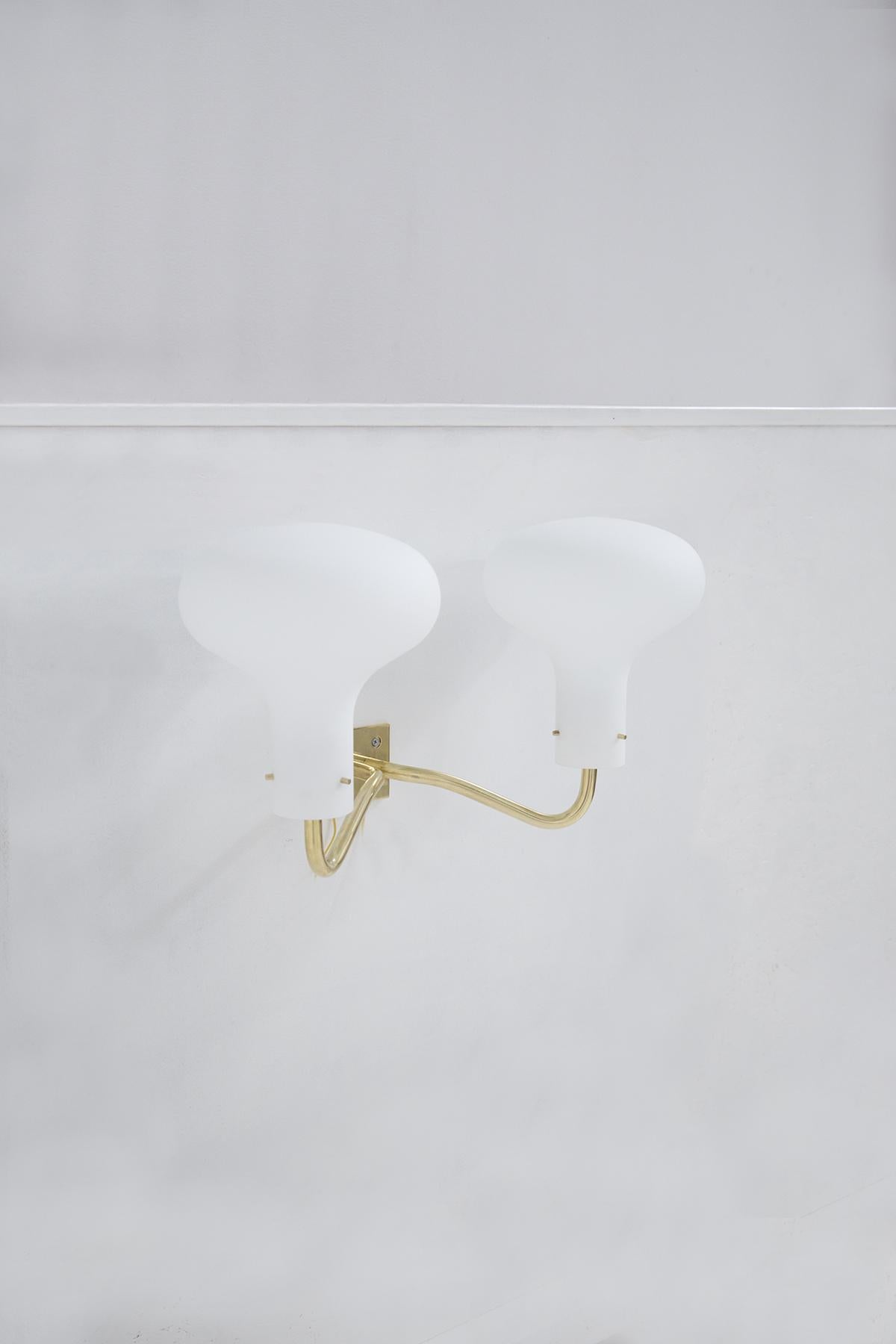Pair of wall sconces by Ignazio Gardella in the 1960s for Italian manufacturer Azucena. The brand is visible in the pictures. The wall base is chrome-plated brass with two arms supporting two white opal glass lights. Each wall sconce holds two