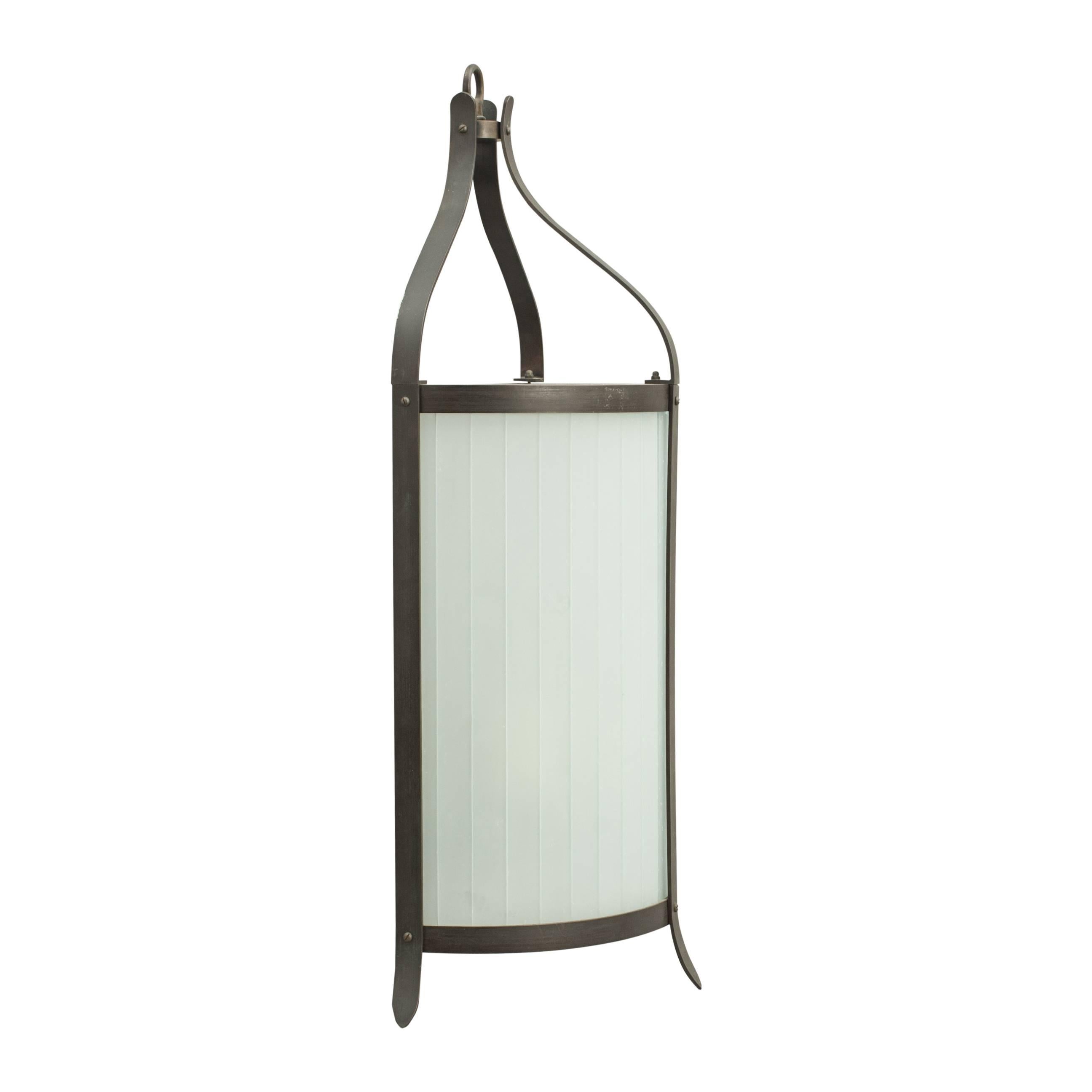 A half round patinated metal and opaque glass wall lantern. The lantern is with three shaped supports with a mirror backed interior. There are two electrical fittings housed inside with bayonet fittings.
The price above is for one light although we